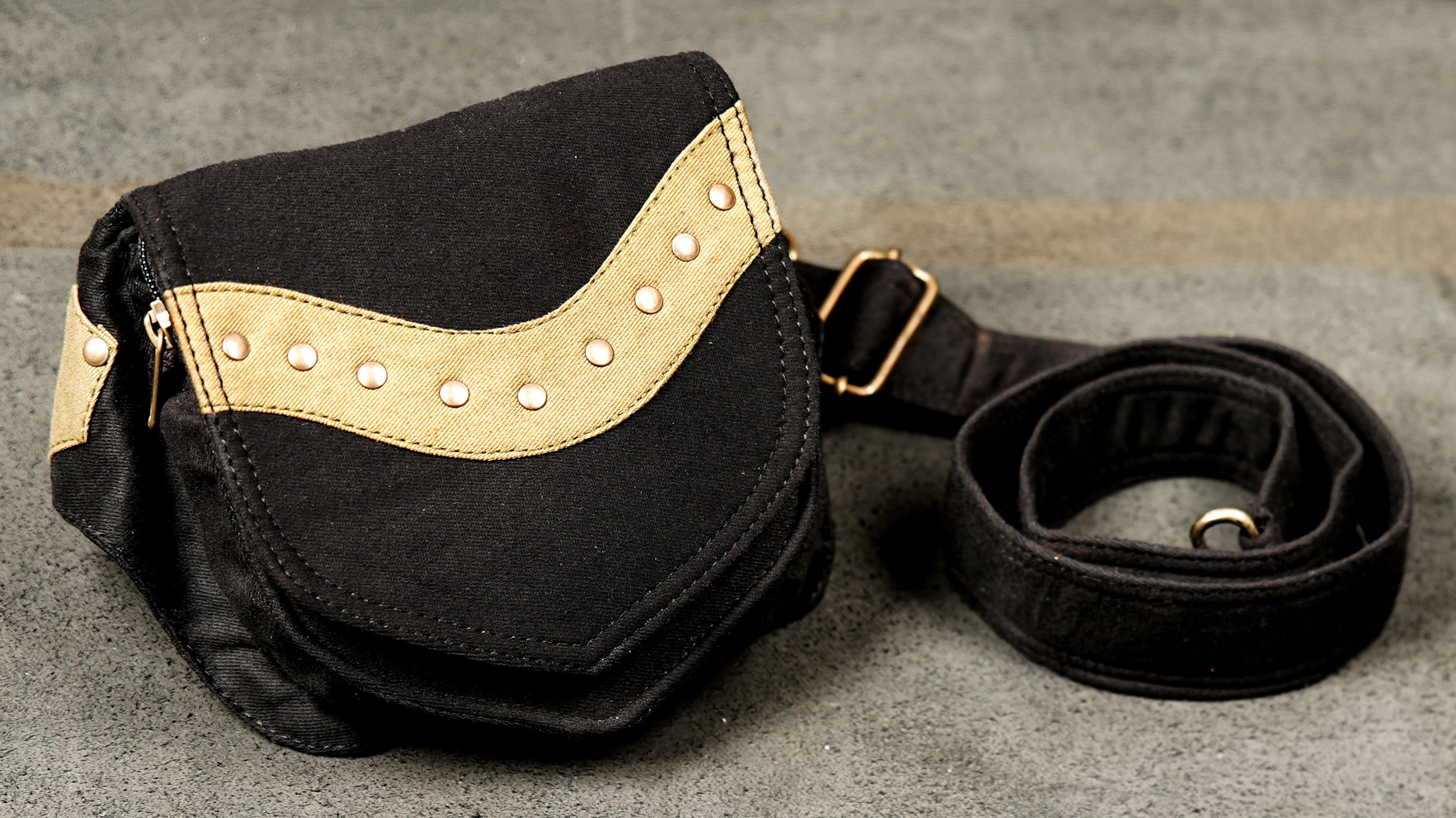 A high-quality product photo of a black cotton waist bag, ideal for hands-free travel or hiking.