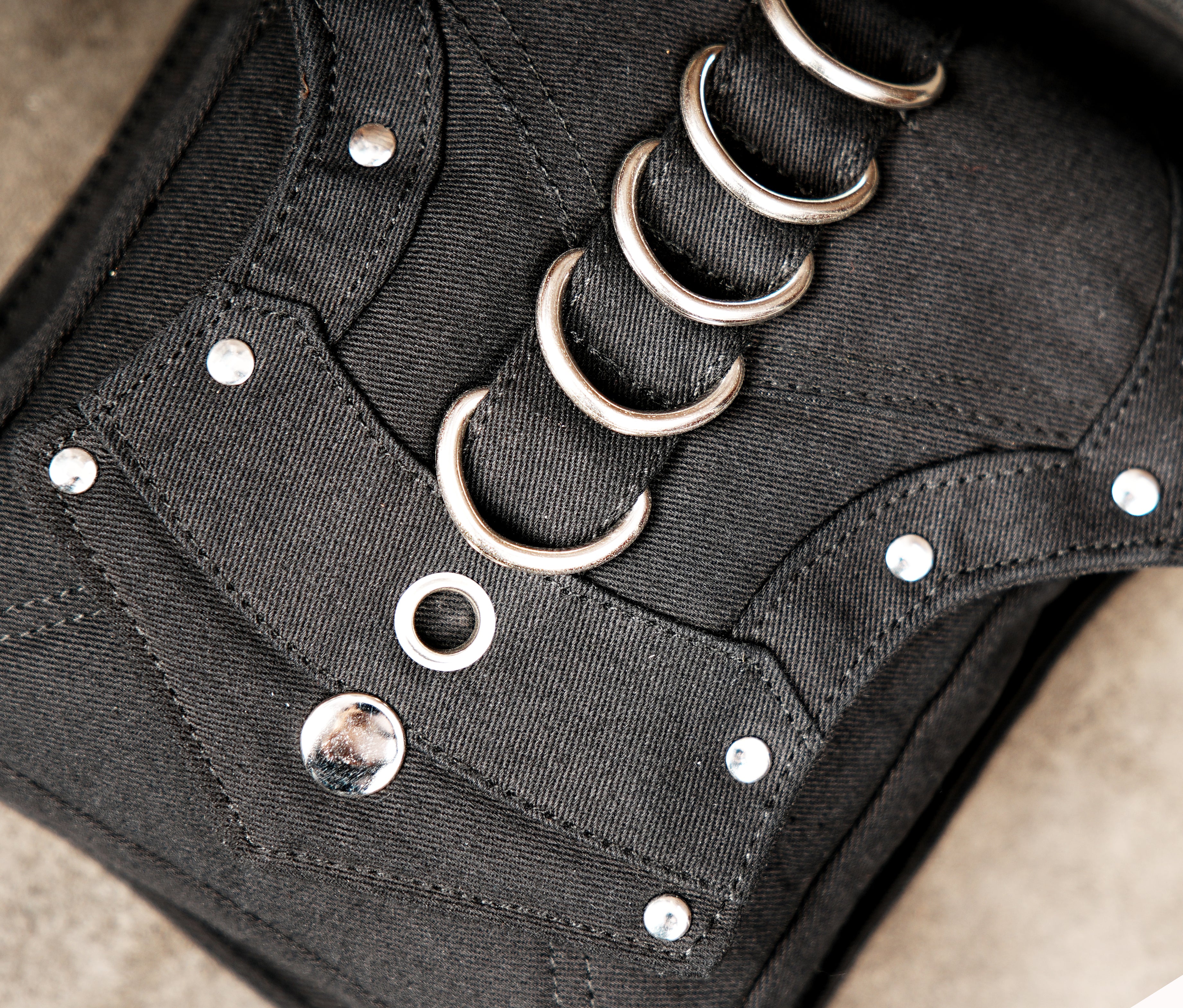 Unisex black canvas hip bag featuring a secure and comfortable leg strap
