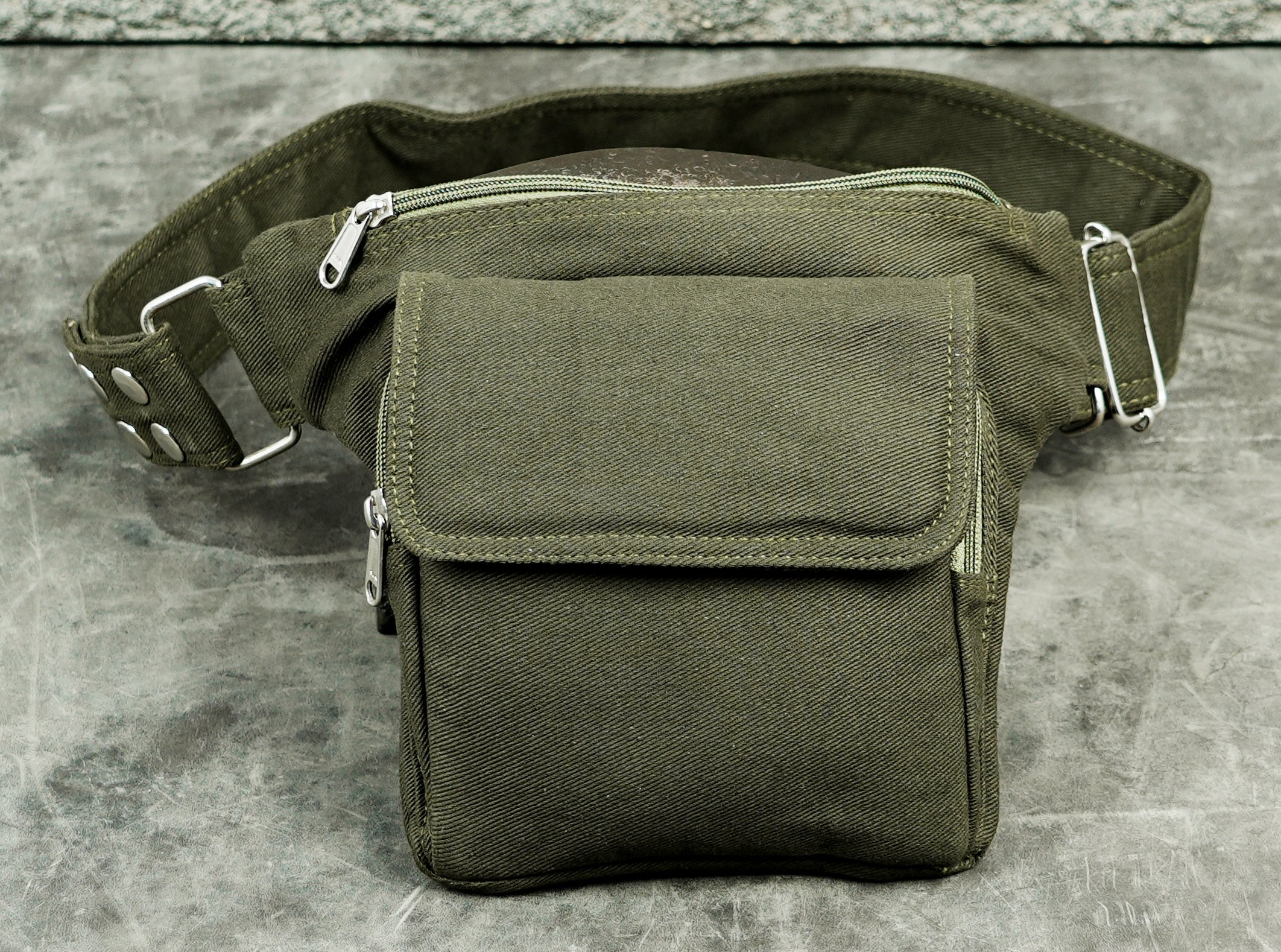 green canvas fanny pack with flap pocket and metal slider buckle