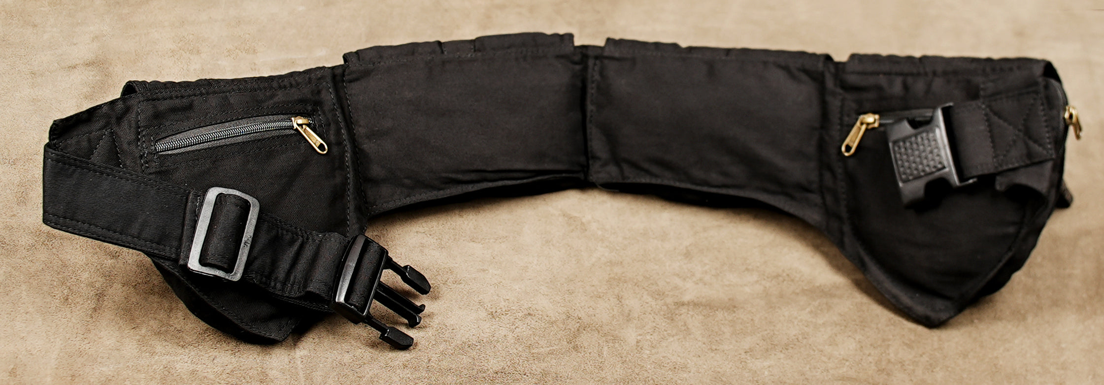 Cotton waist pocket belt in black with zip compartments behind snap flap pouches