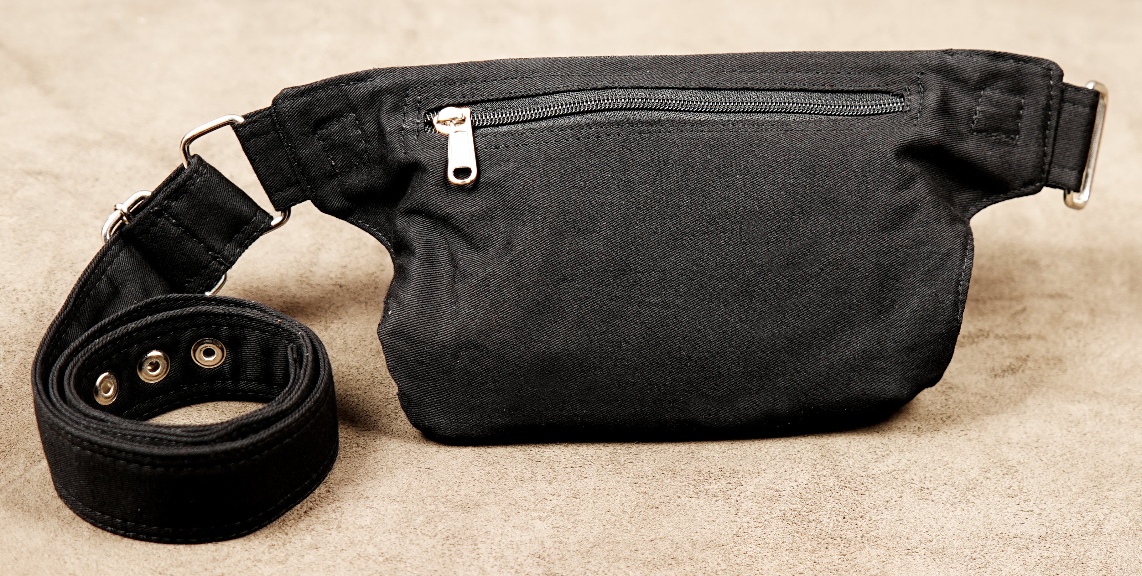 Durable canvas bum bag with silver hardware accents for a punk aesthetic.
