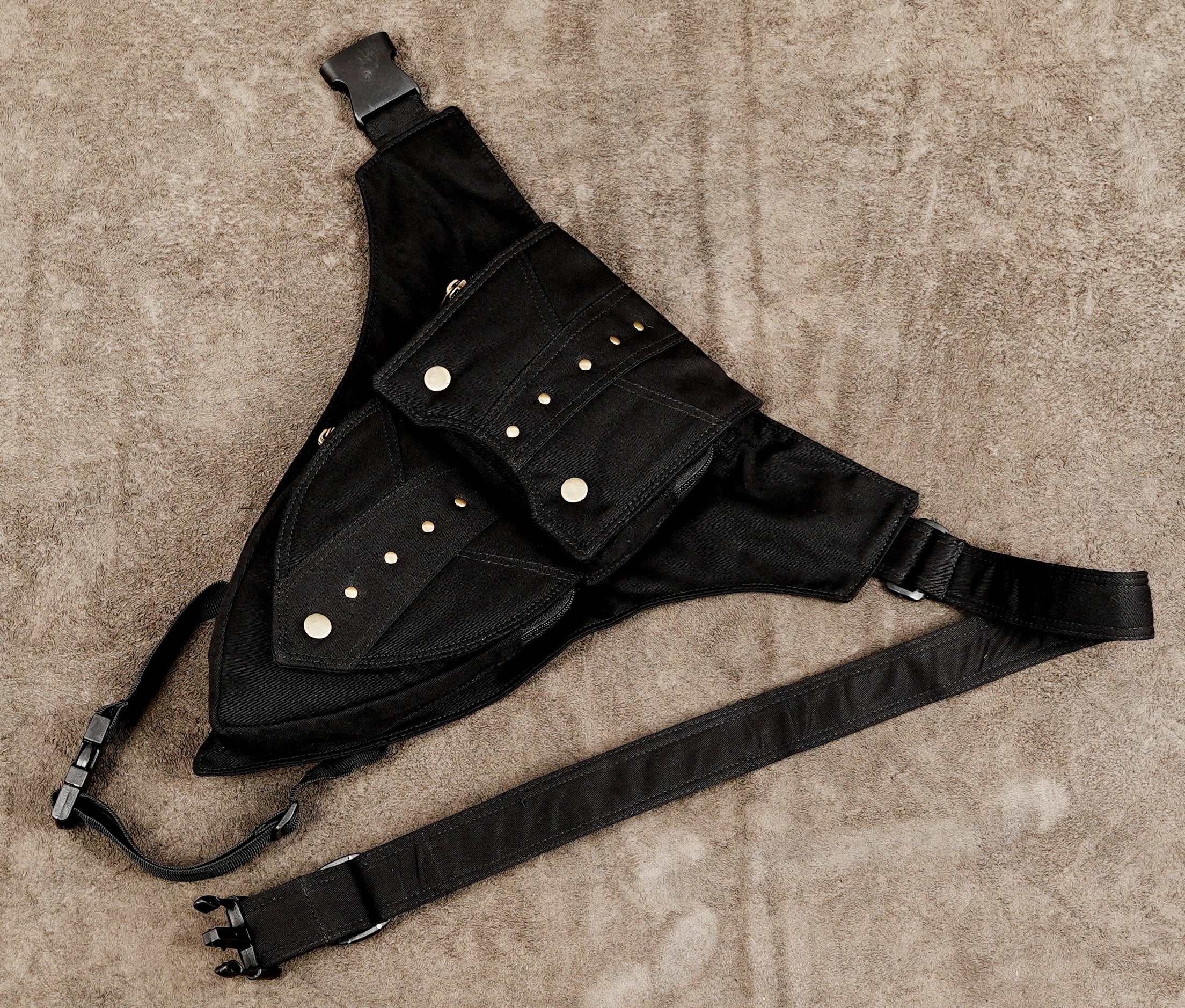 Zippered hip pocket belt with brass pull tabs in black cotton fabric