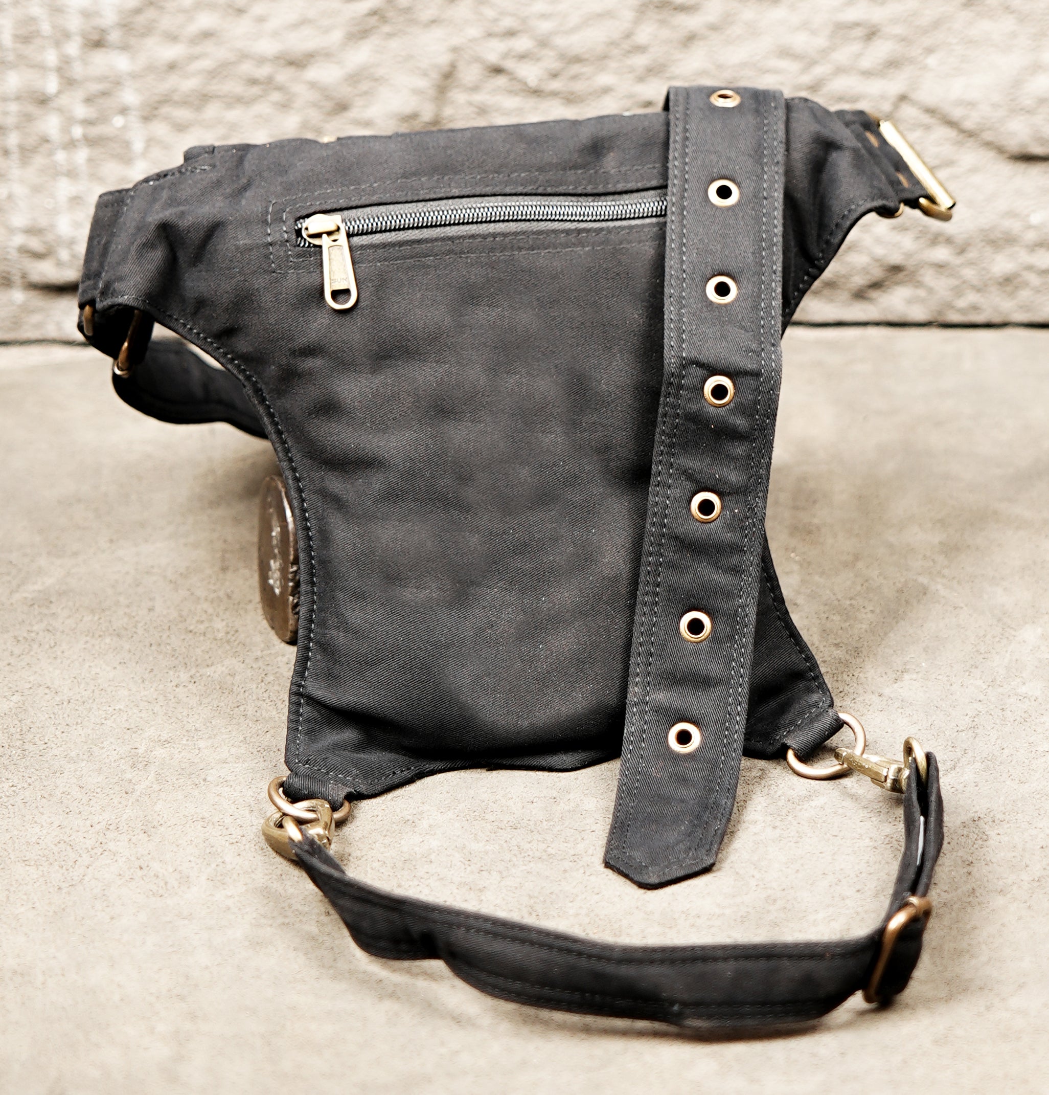 Biker style cotton thigh bag with swivel snap hooks and zippered compartments.