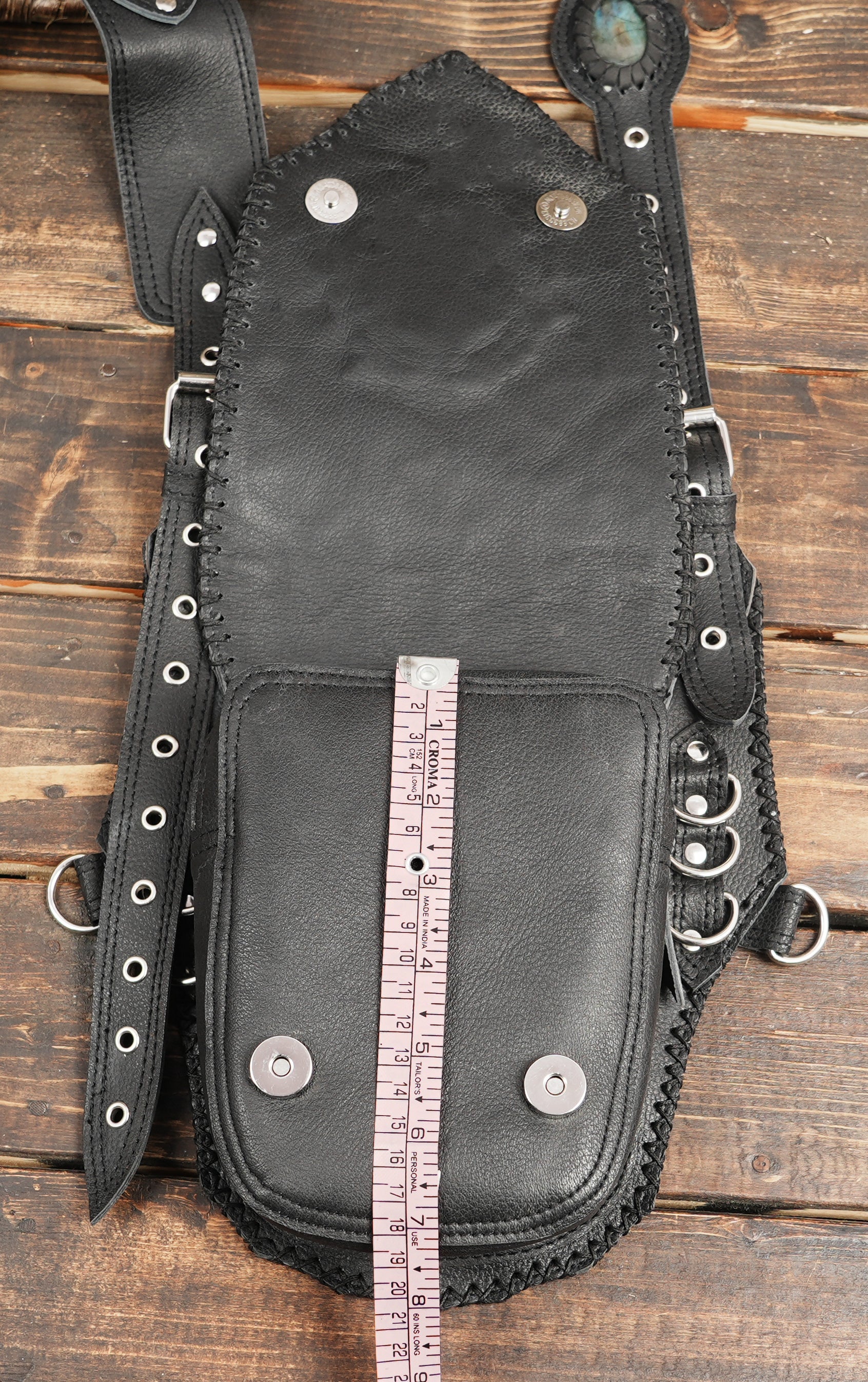 Multi-strap leather holster with detailed embossing and dual storage pockets