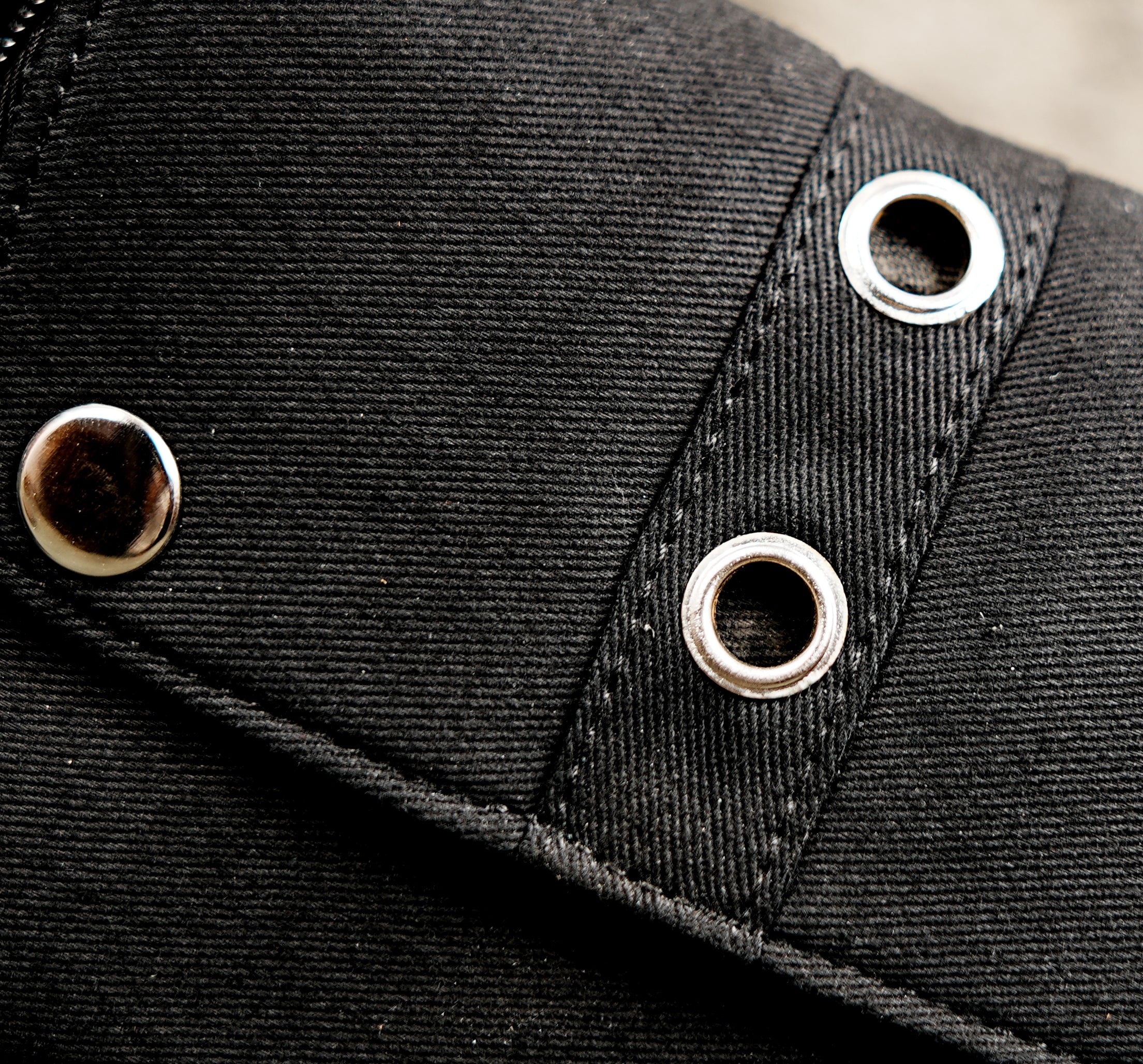 Black cotton cargo waist belt with utility pockets and silver-tone buckle for music festival accessories.