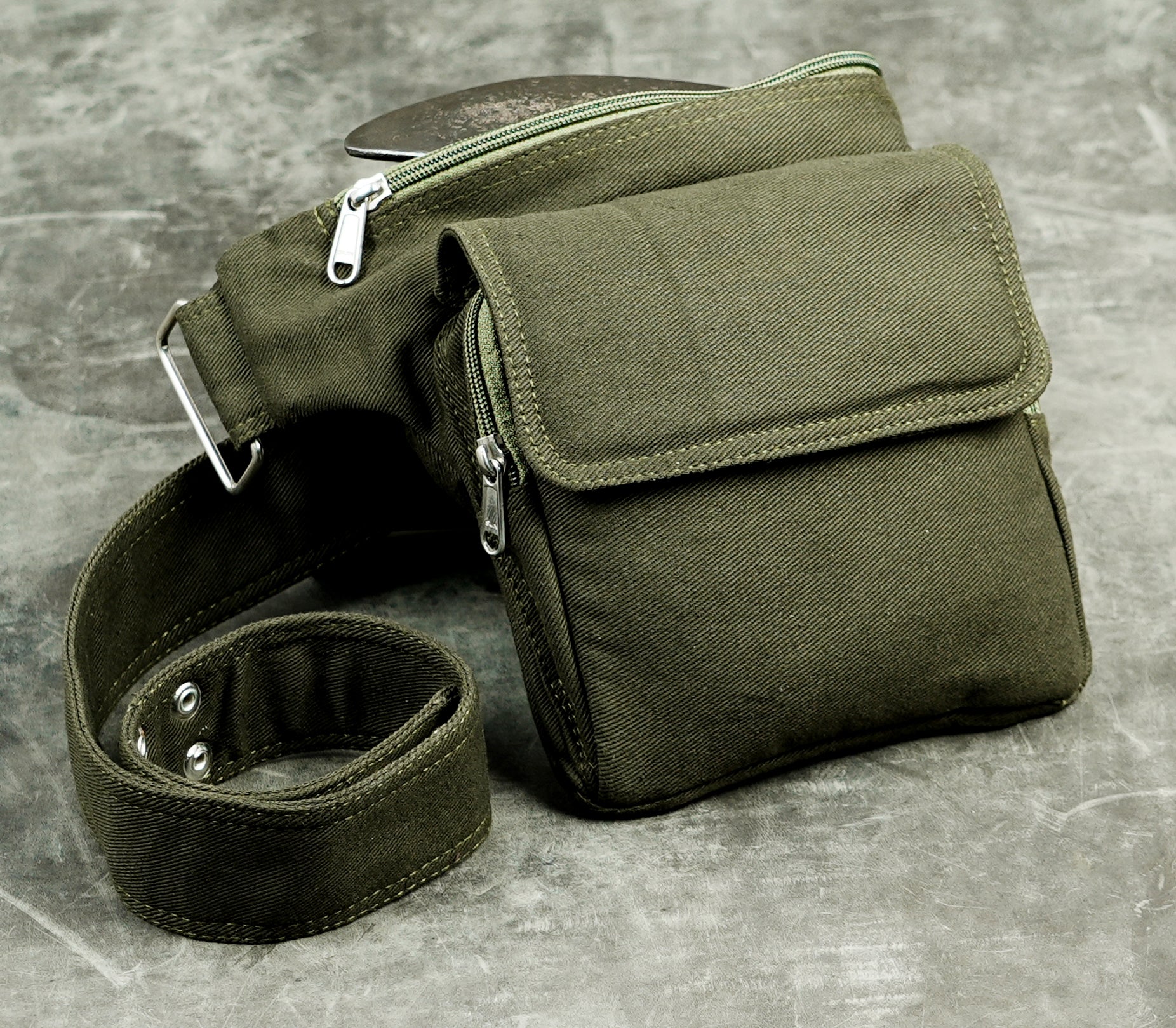 Compact olive canvas belt pouch with zip and flap closures