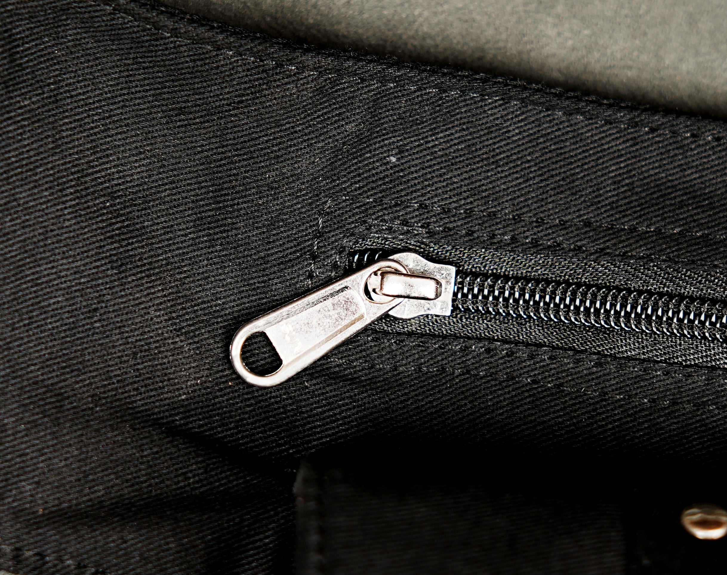 Black cotton punk fashion belt bag with metal studs eyelets and adjustable waist fastening.