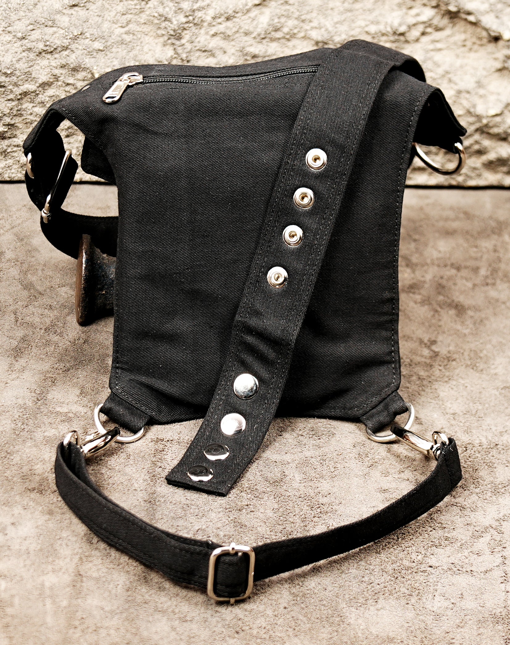 Edgy festival hip bag featuring metal rings and a secure leg strap