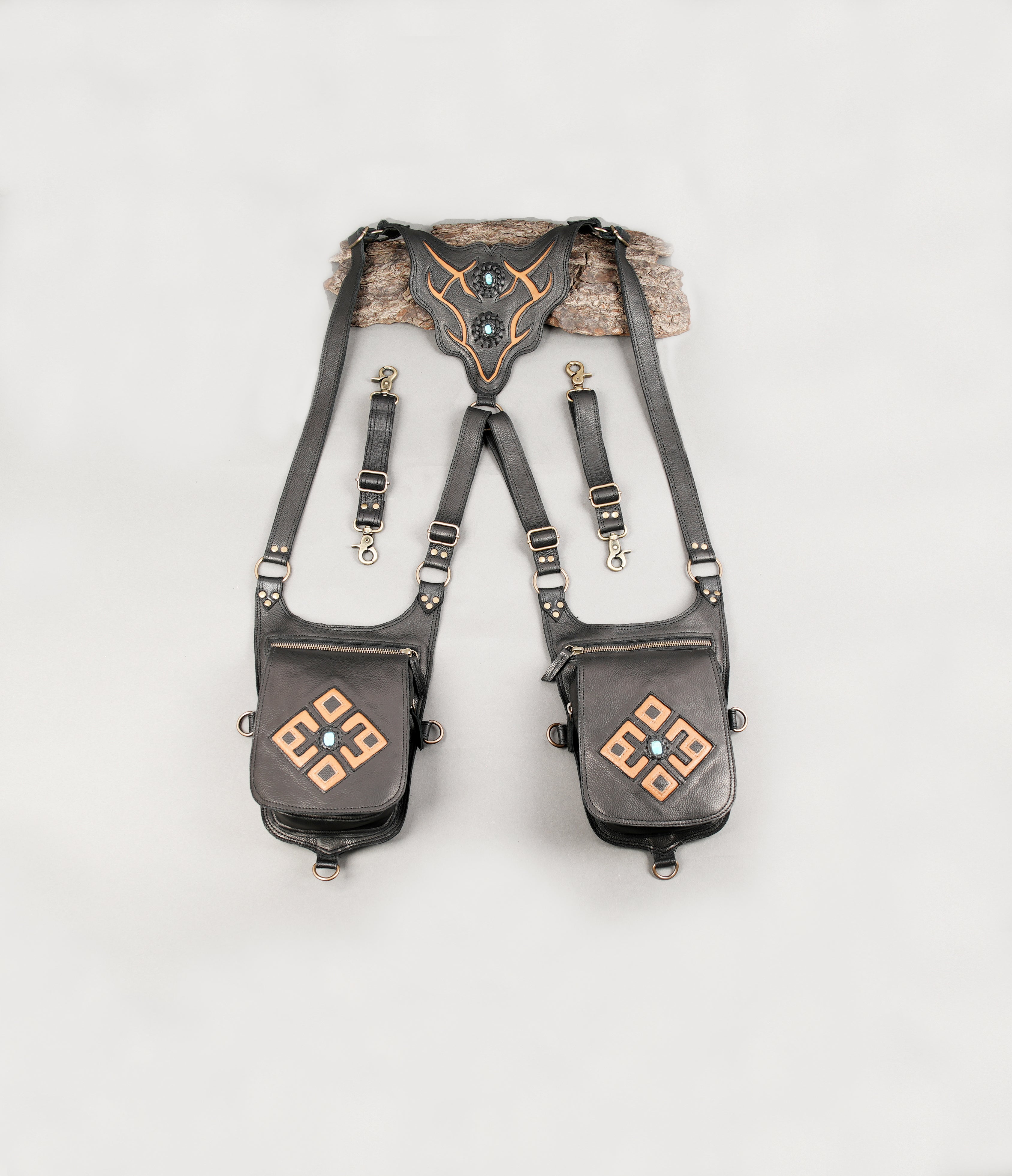 Black leather holster with dual pouches and adjustable straps.