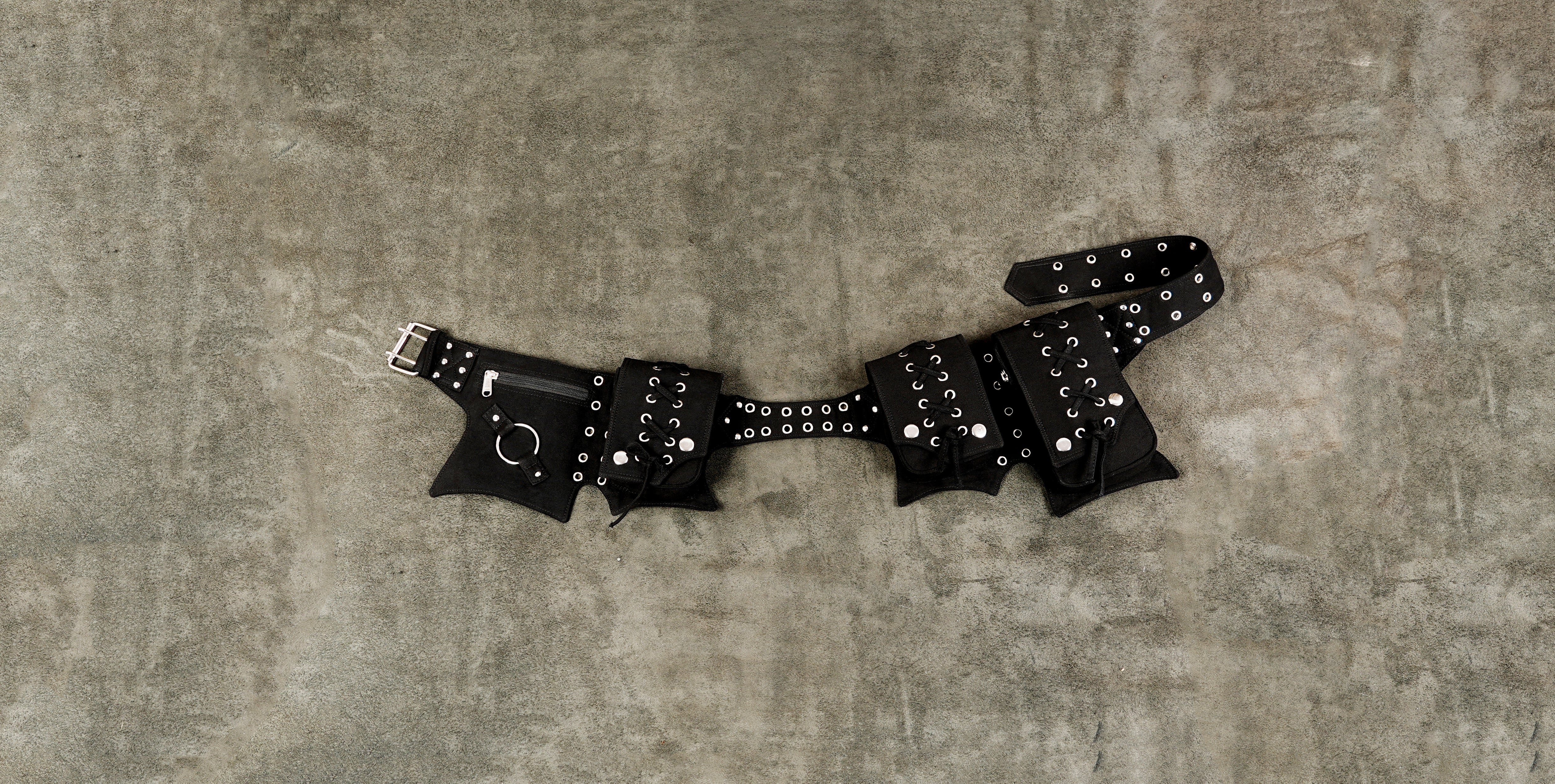 Black cotton utility waist belt with multiple pockets and silver eyelets