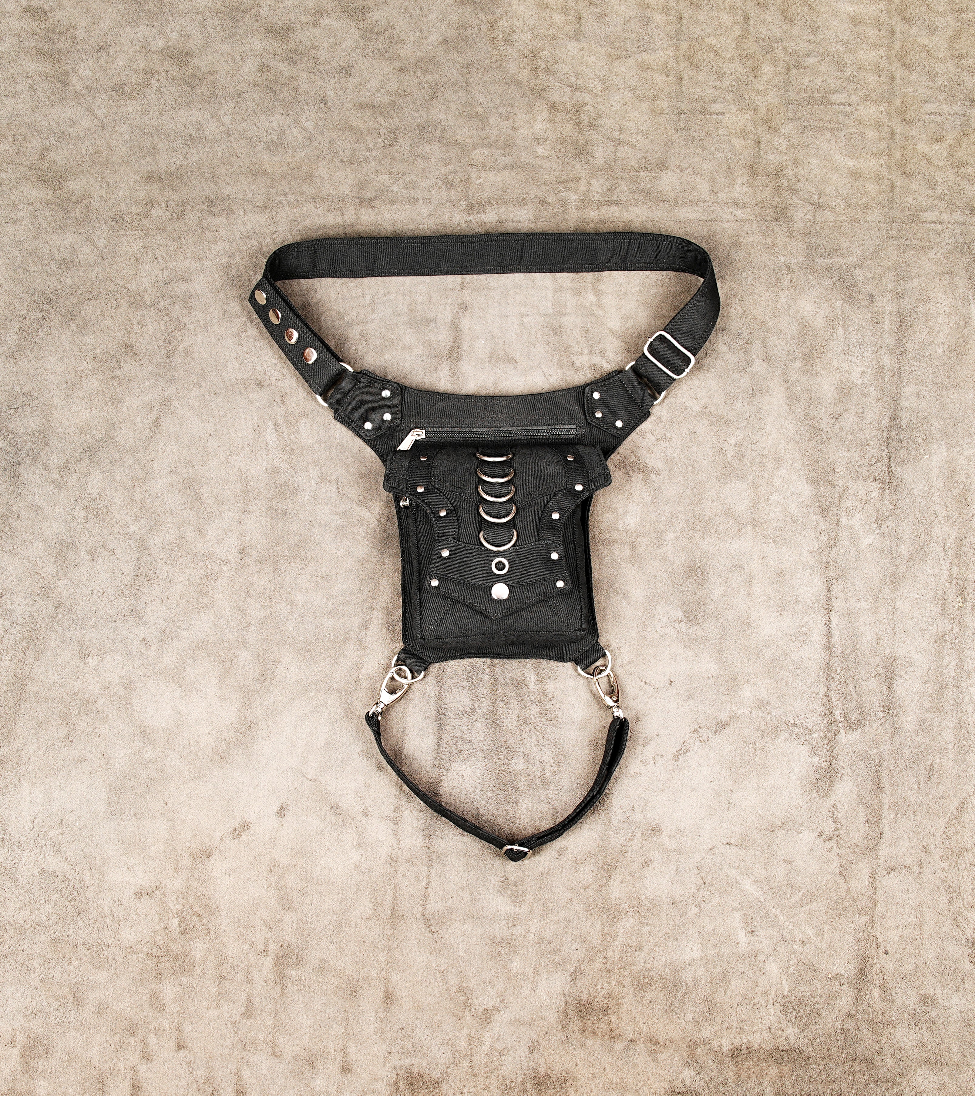 Black cotton canvas drop leg bag featuring silver metal rings and studs