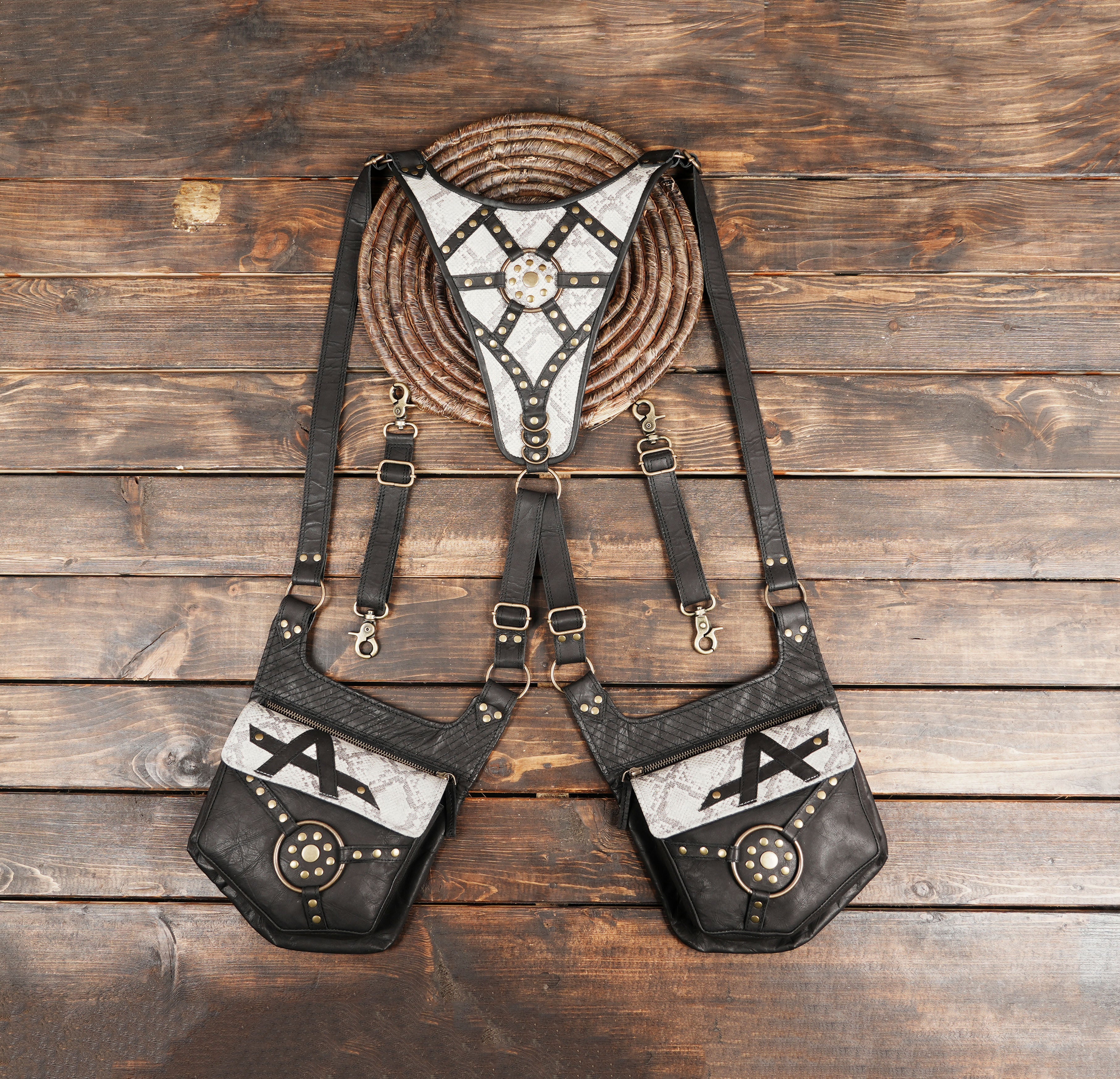 Handmade leather holster harness with snakeskin texture and brass studs.