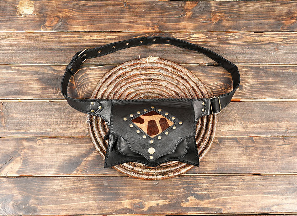 Close-up of black leather fanny pack with animal print cowhide insert