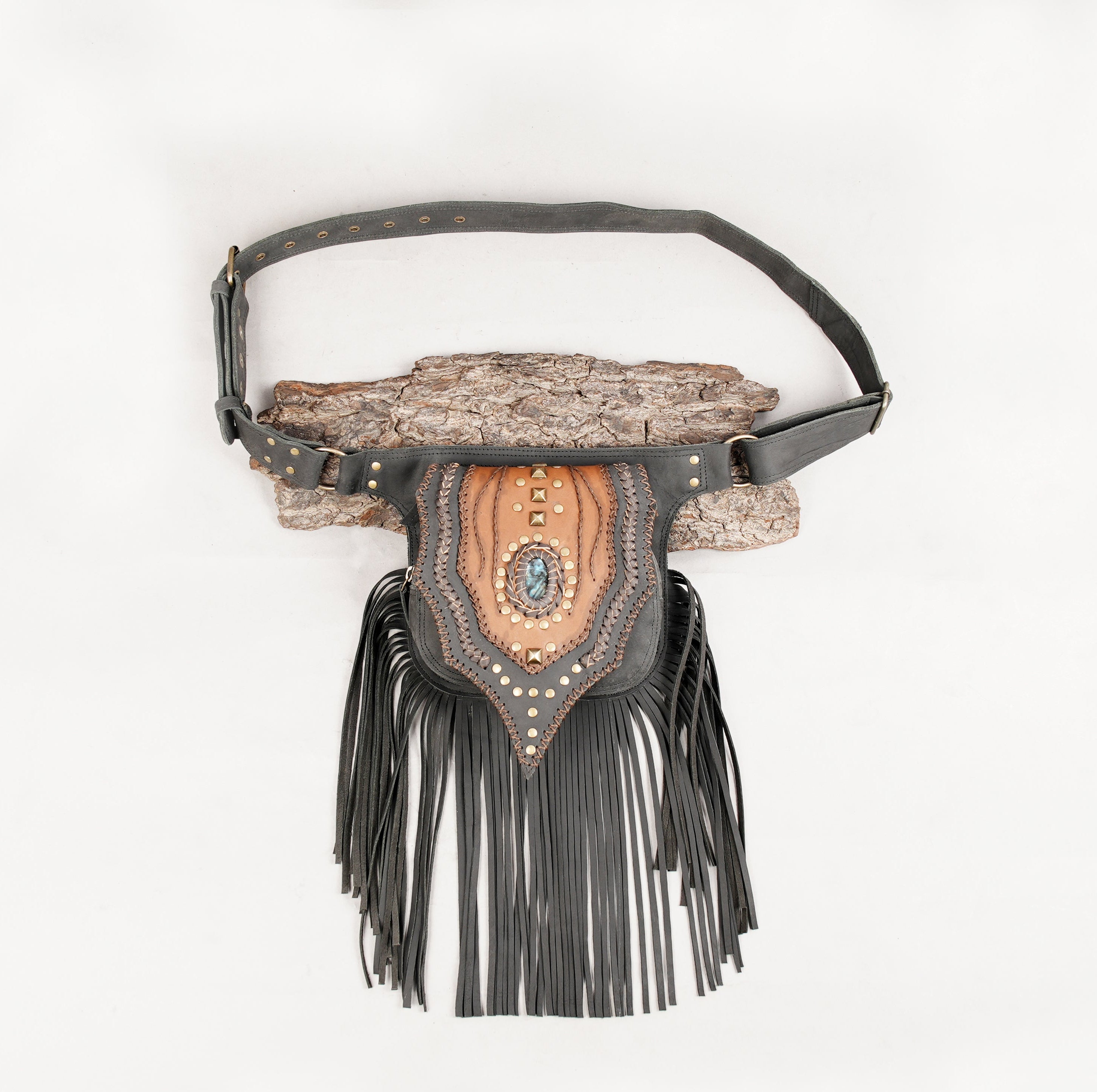 Handmade leather waist belt with gemstone centerpiece and long fringe.