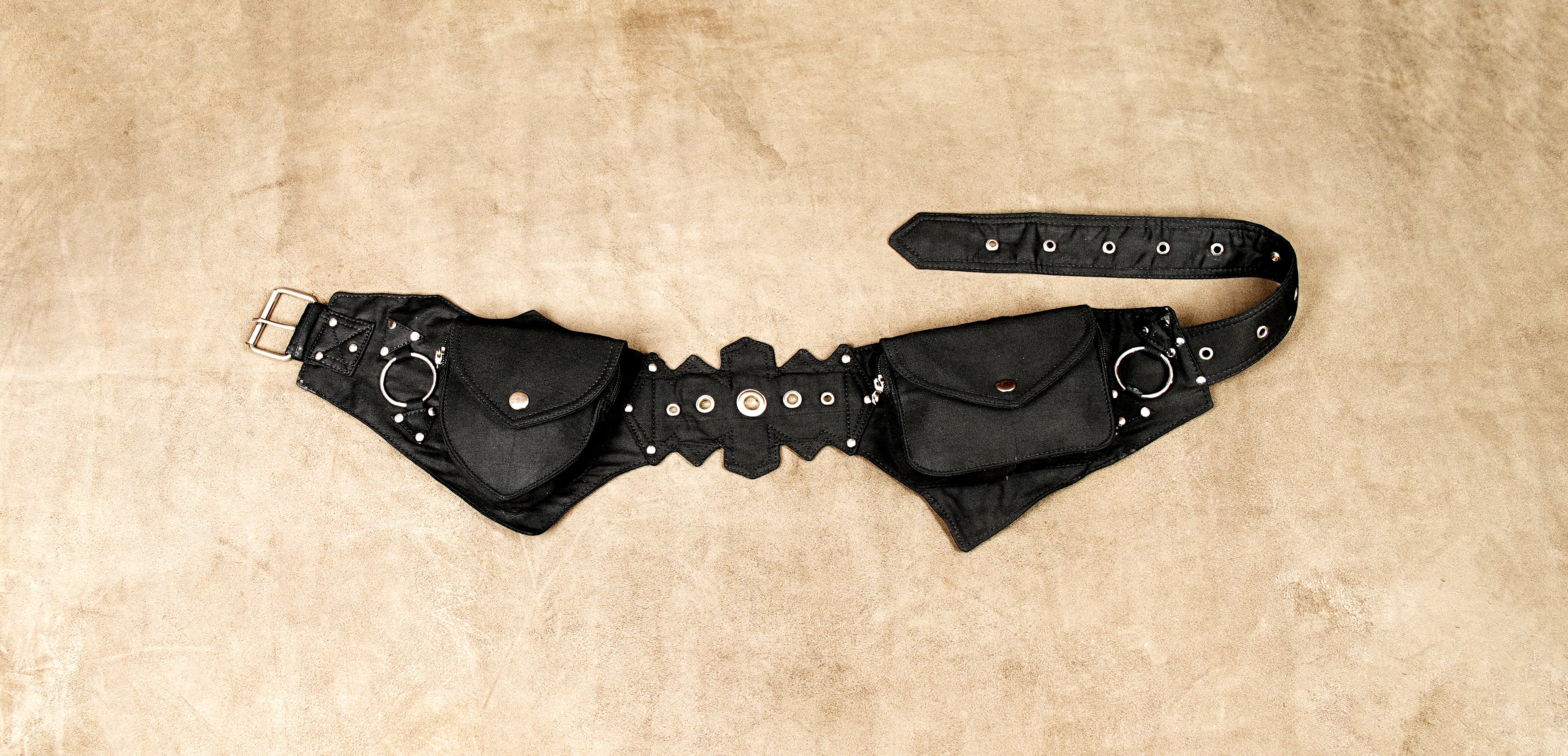 Black canvas utility belt with multiple pouches and metal studs.