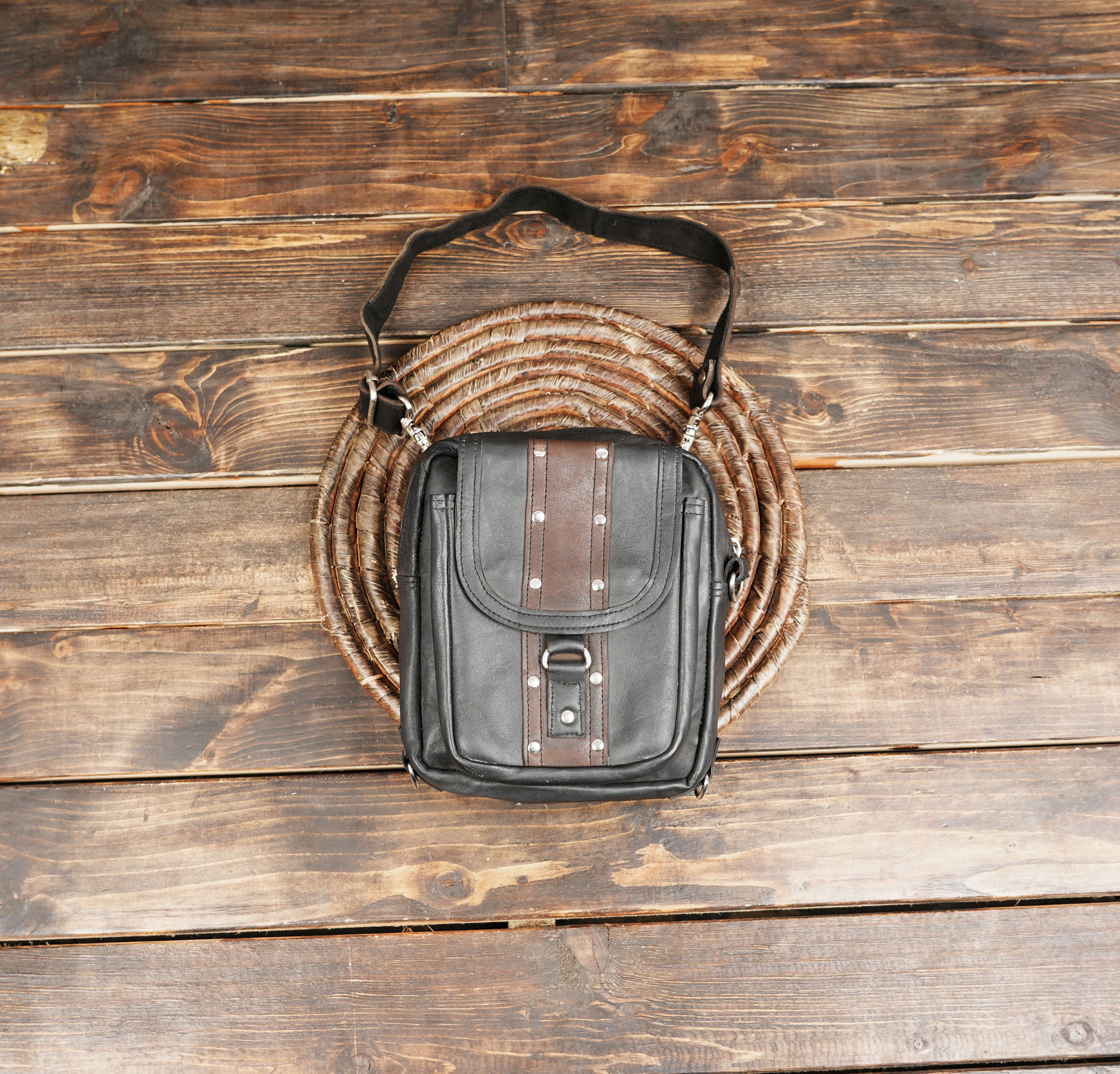 Black leather waist belt bag with brown accent and rivets