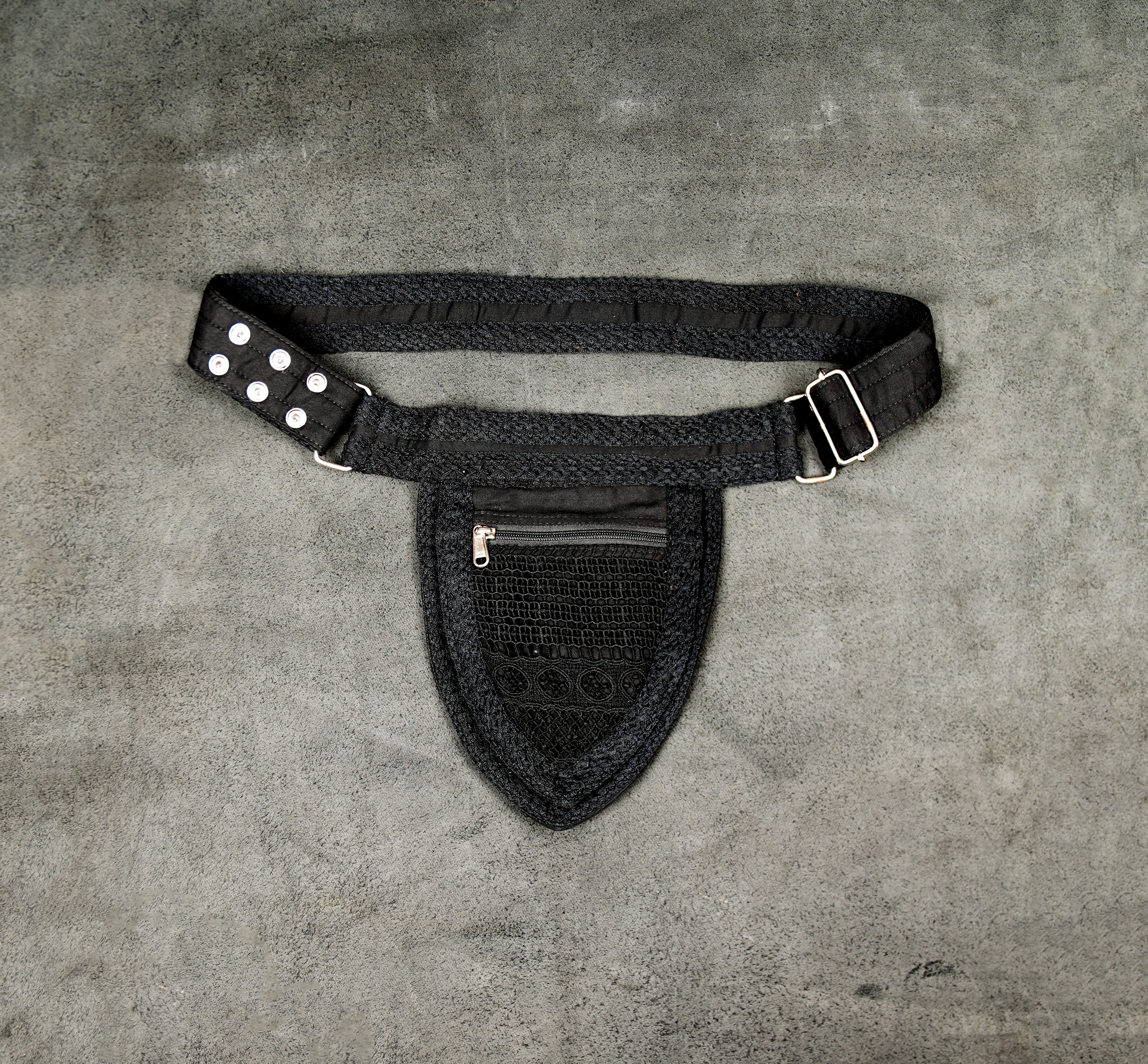 Black festival utility belt bag with zippered pouch and silver grommet details