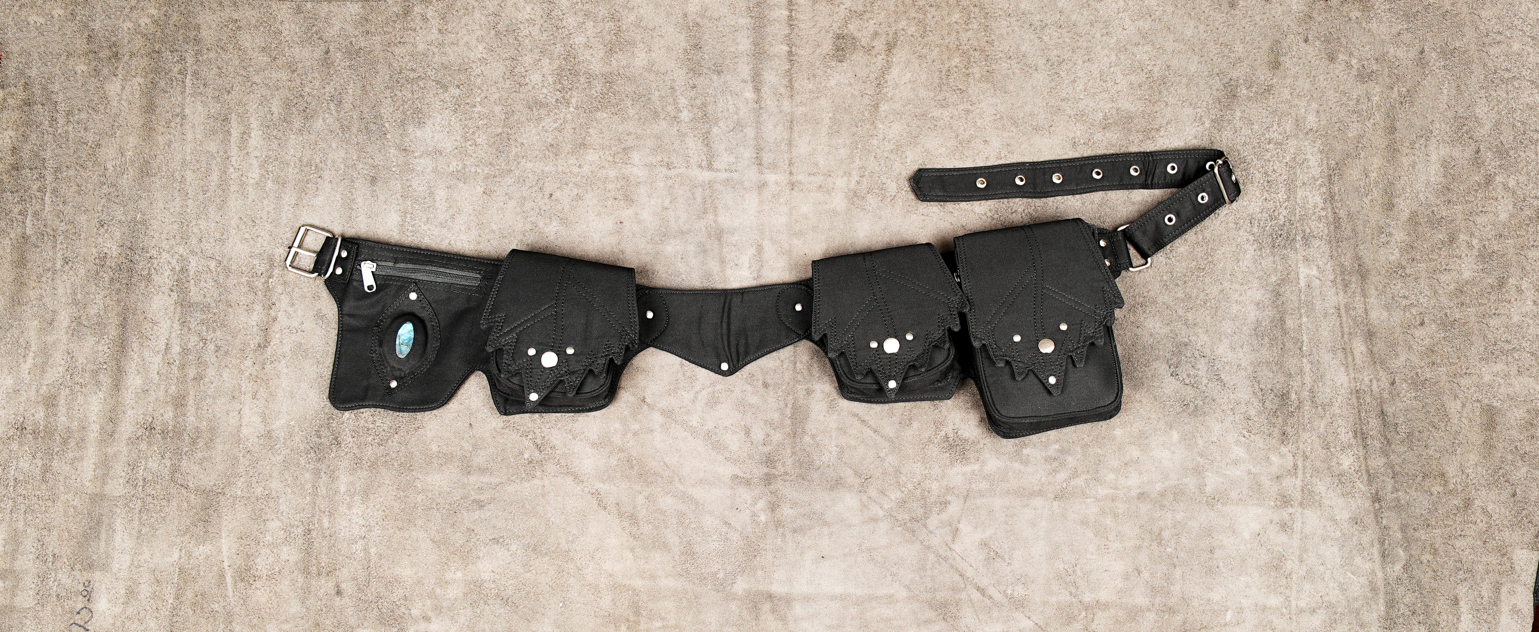 Black canvas utility belt with multiple pouches and metal studs.