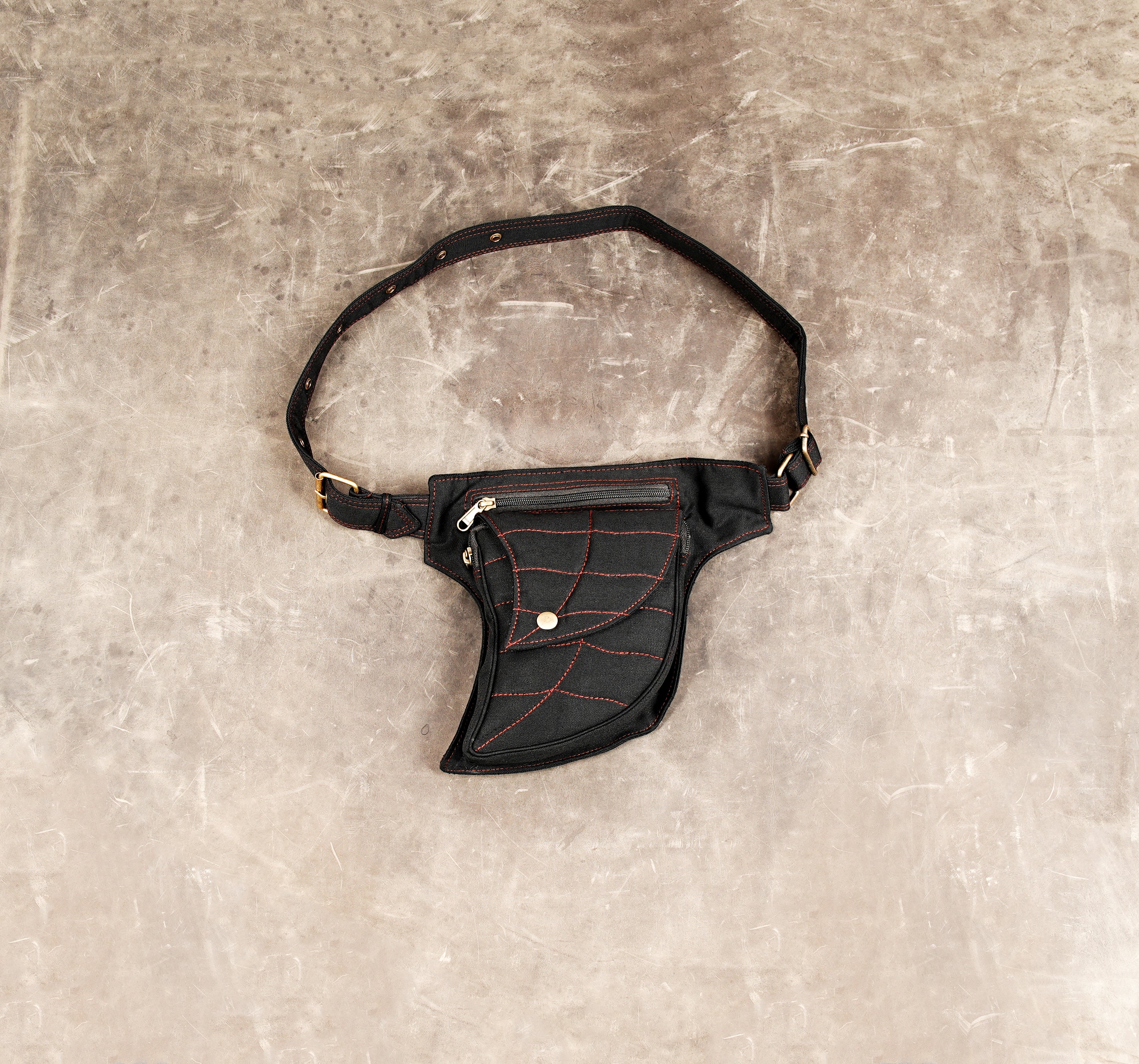 Black cotton waist belt bag with red stitched leaf pattern design.