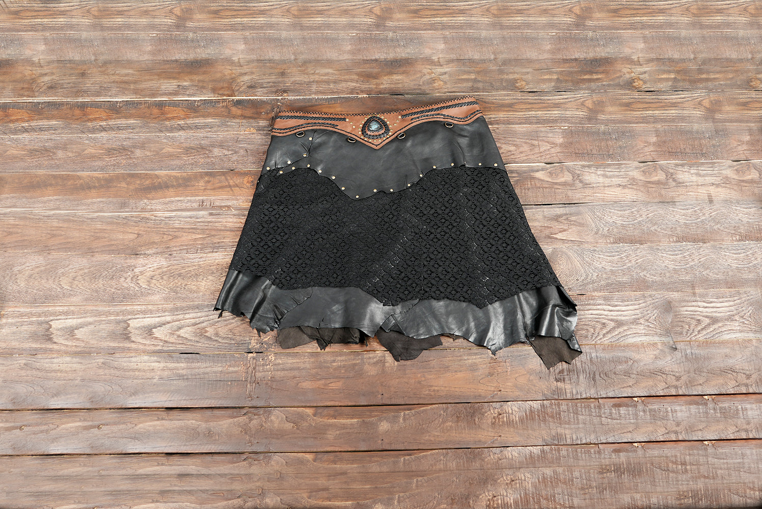 Genuine leather festival skirt with gemstone accent.