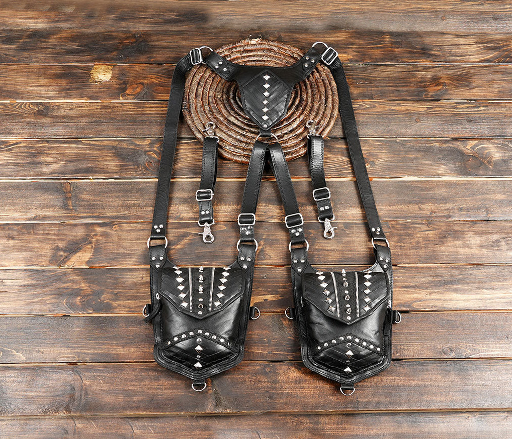 Black leather dual shoulder holster with heavy studded detailing