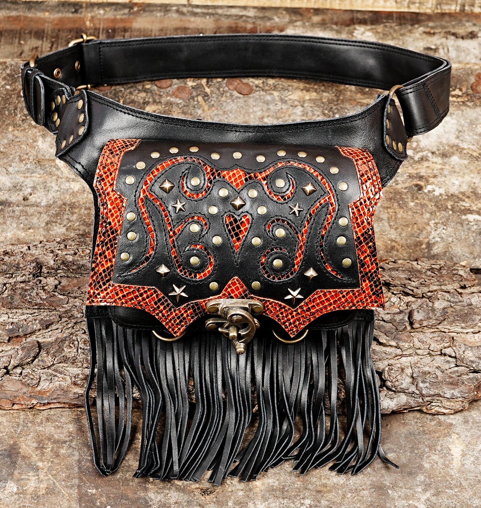 Handmade leather waist belt with red snakeskin pattern, metal studs, and black fringe