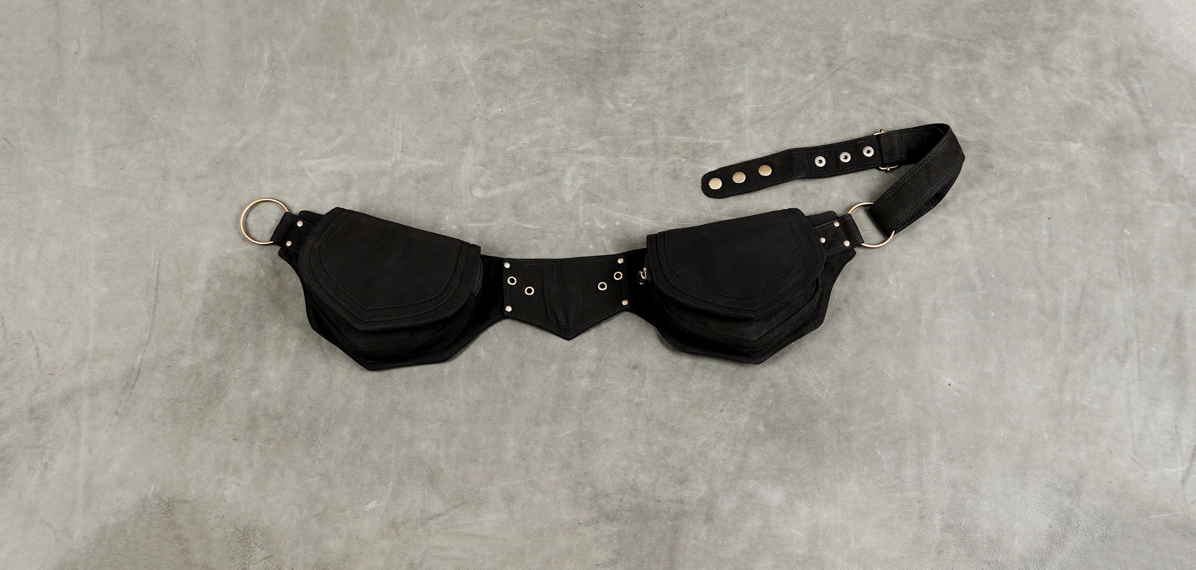 Black cotton belt bag set with two large pouches, a central buckle strap, and brass hardware