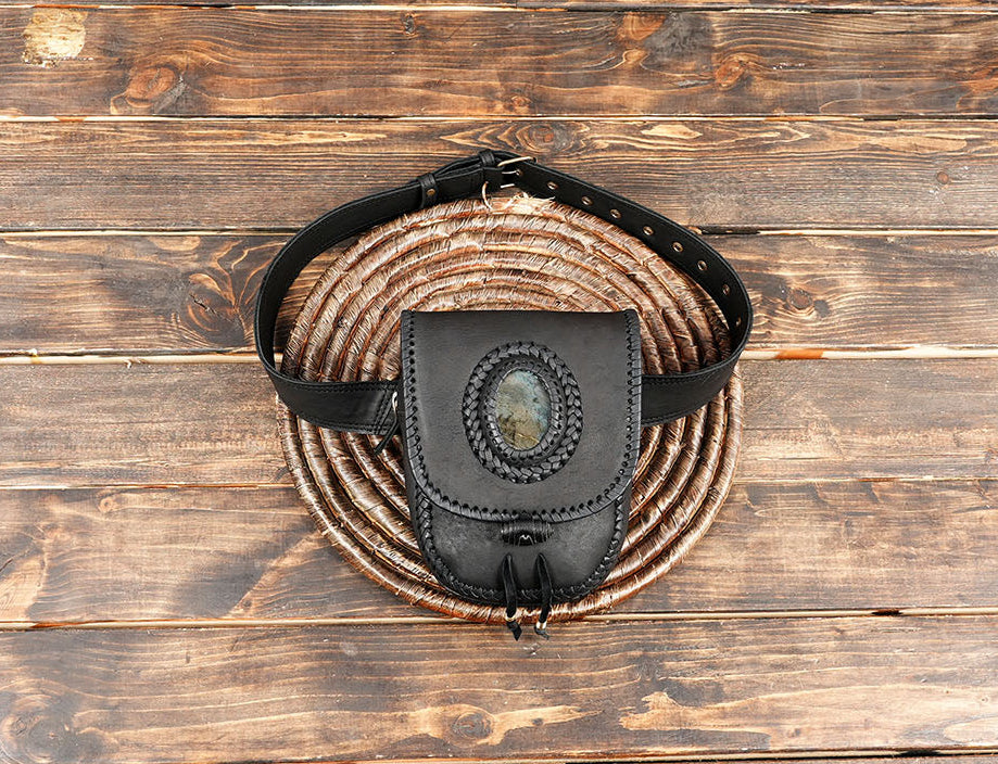 Handcrafted black leather belt bag with natural stone accent and braided stitching