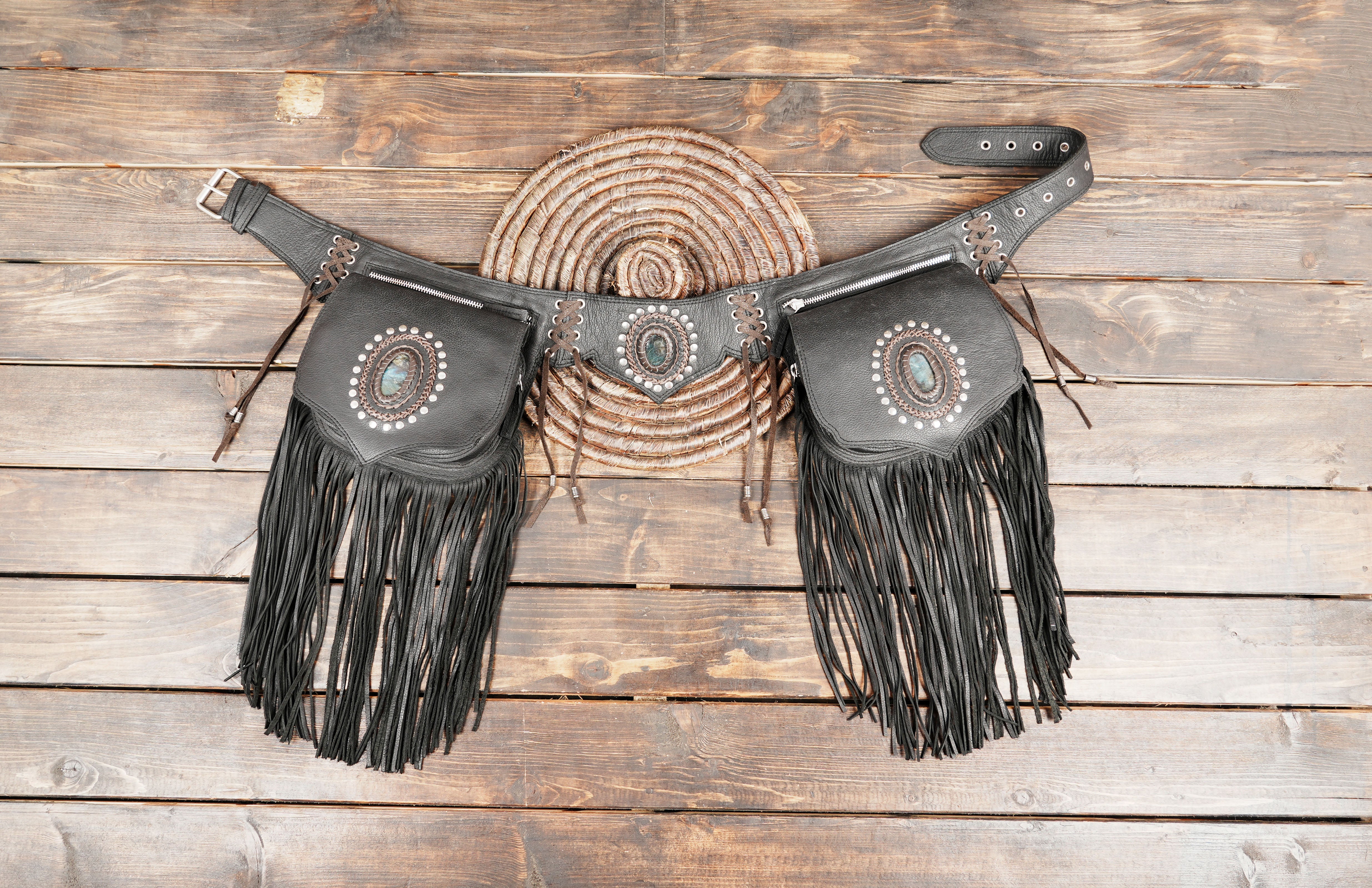 Black leather waist belt with dual fringe pouches and gemstone detail