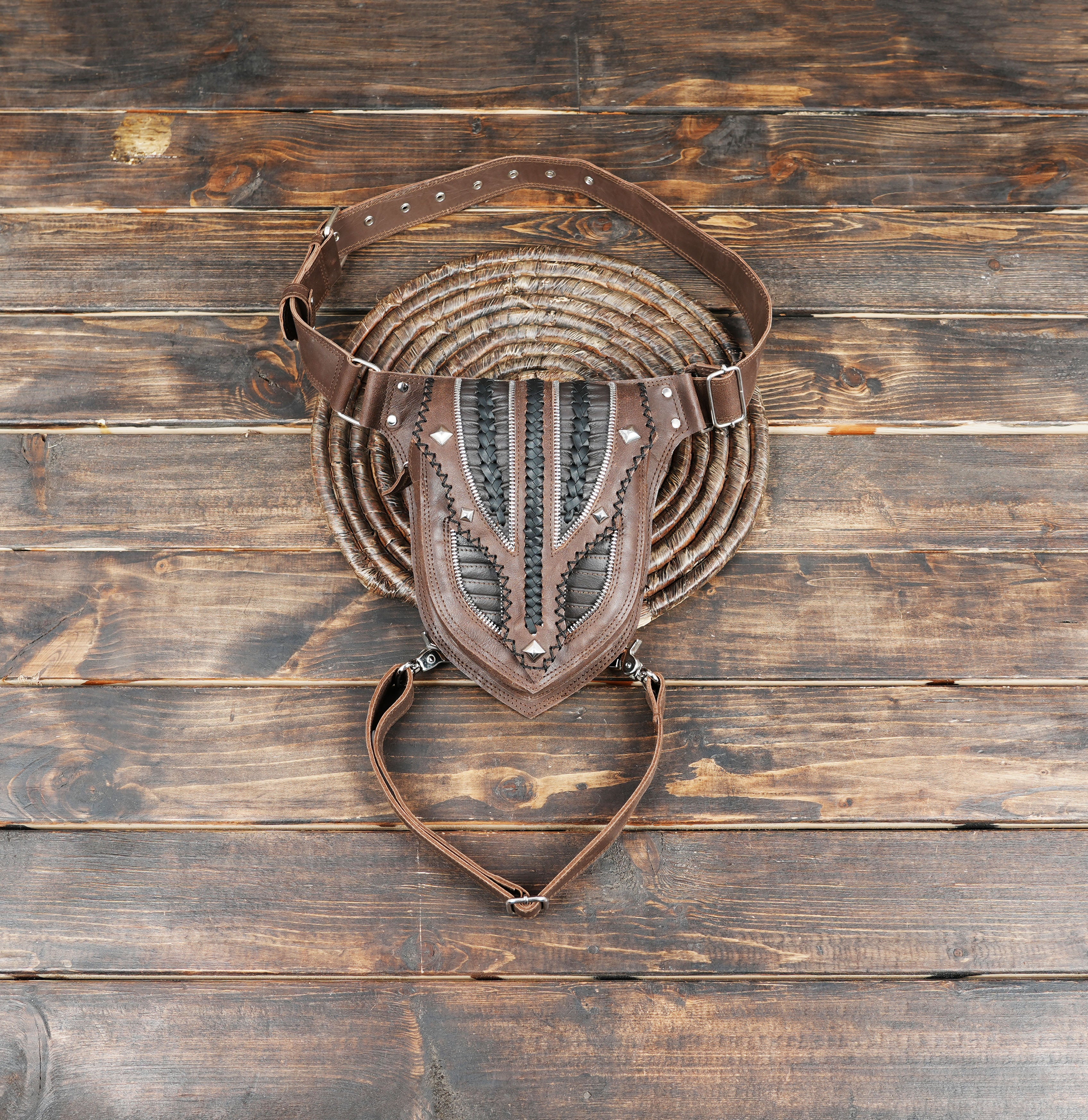 Handmade brown leather waist and thigh belt with braided black detailing.