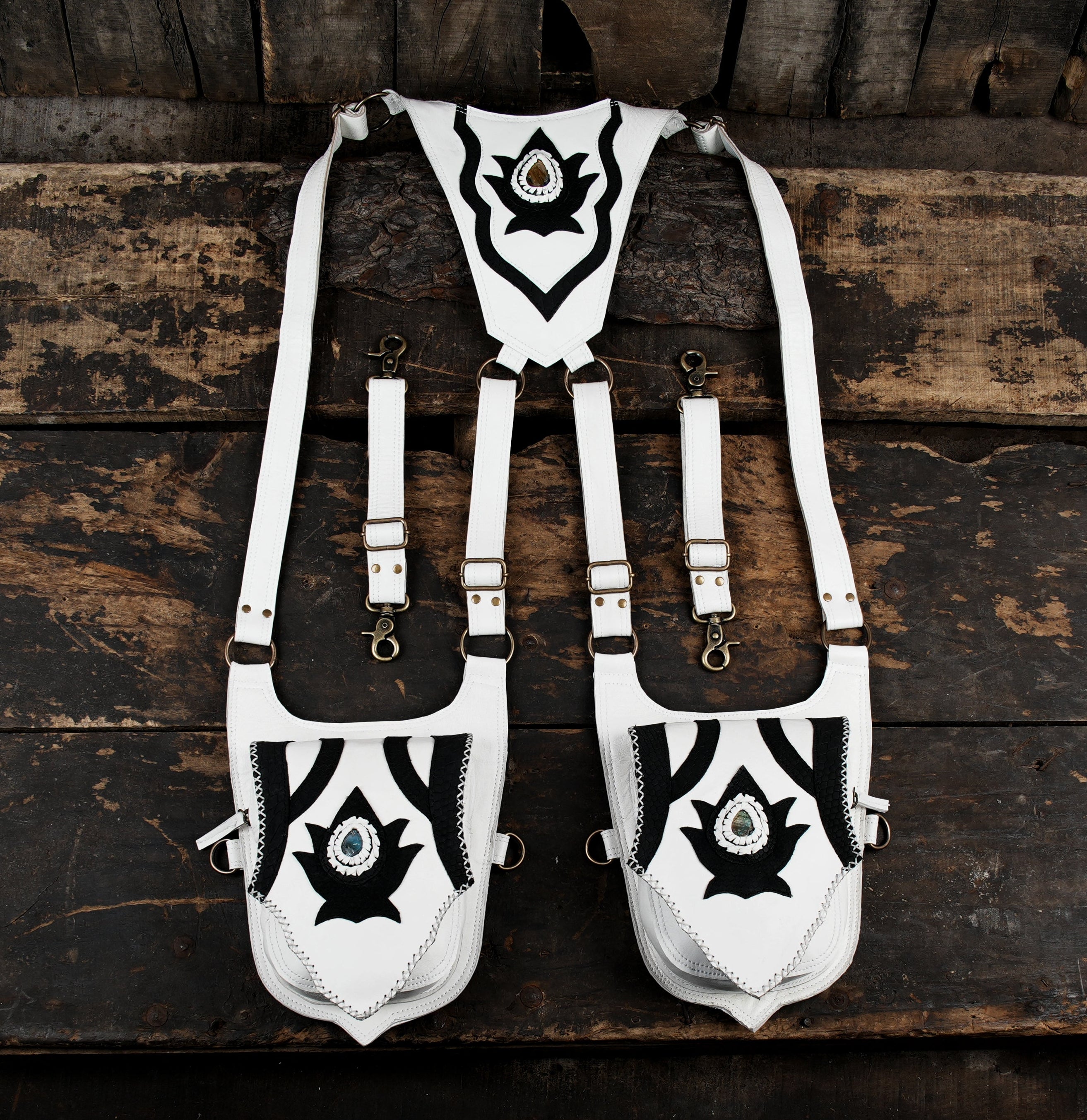 “White leather double holster with black tribal design and gemstone accents”