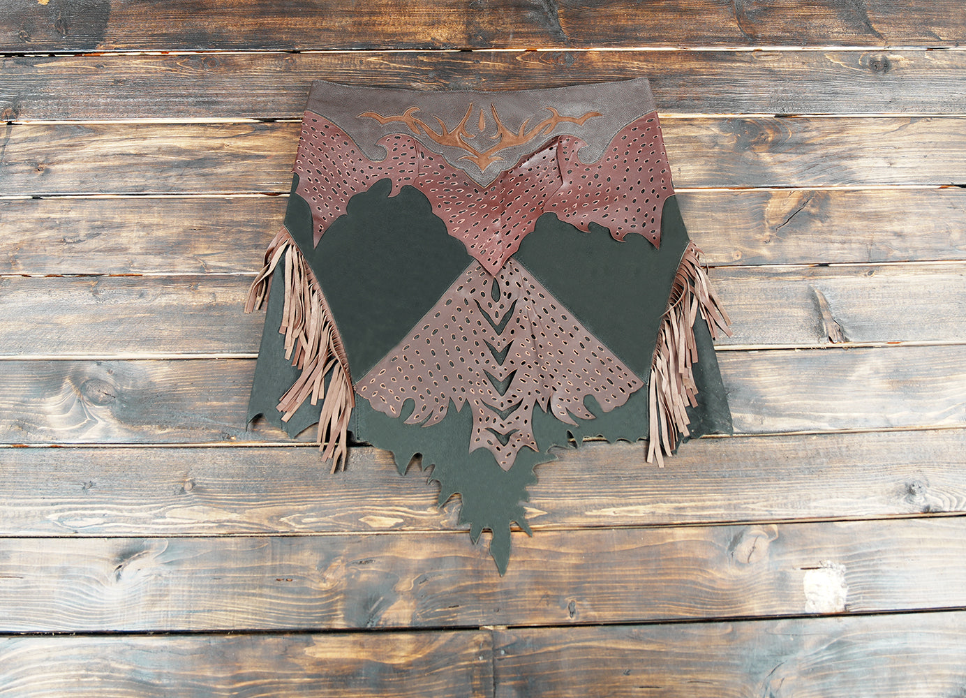Handmade Western leather fringe skirt for women on rustic wooden background