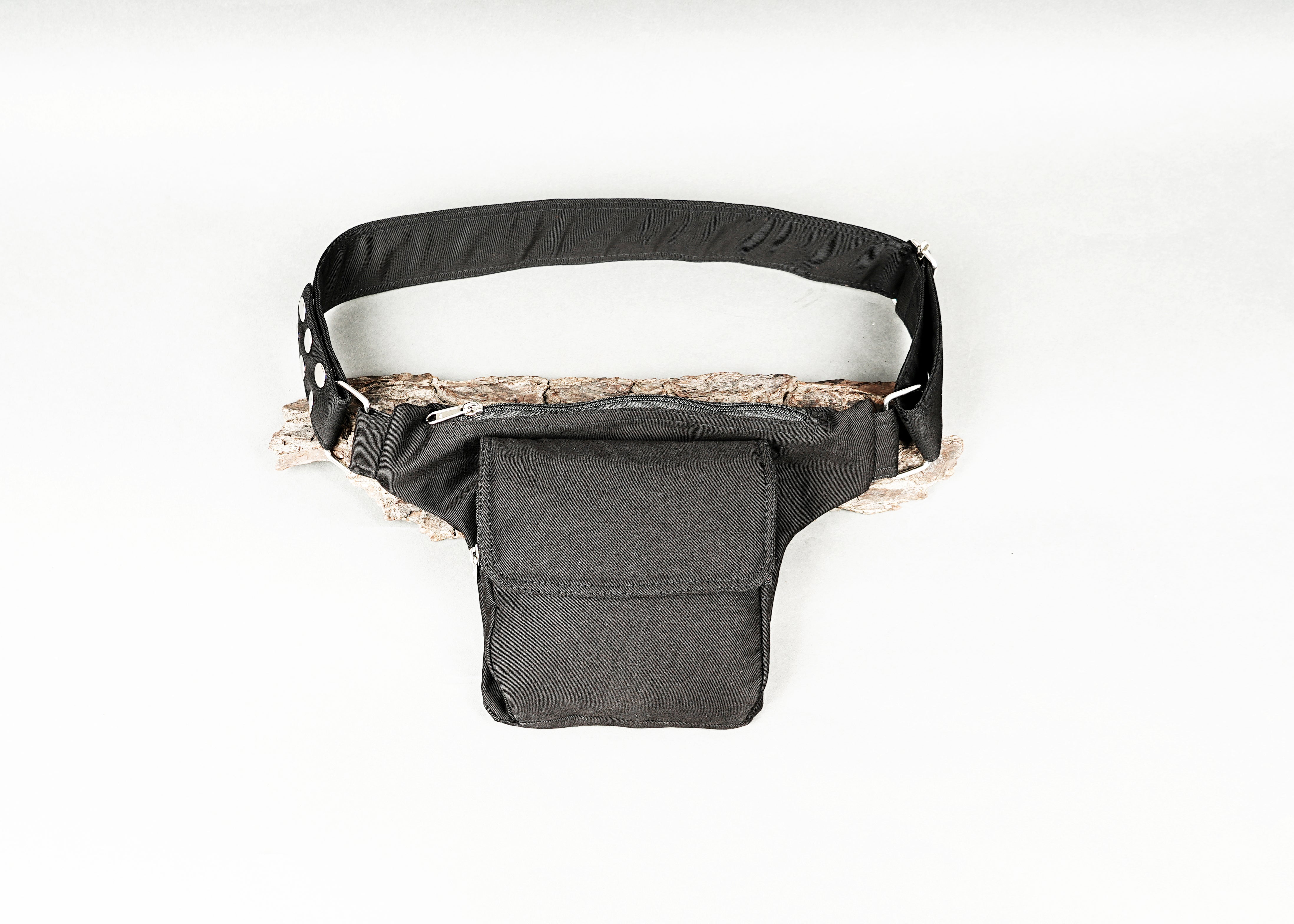 Adjustable waist pack made of black canvas material with one secure pocket.