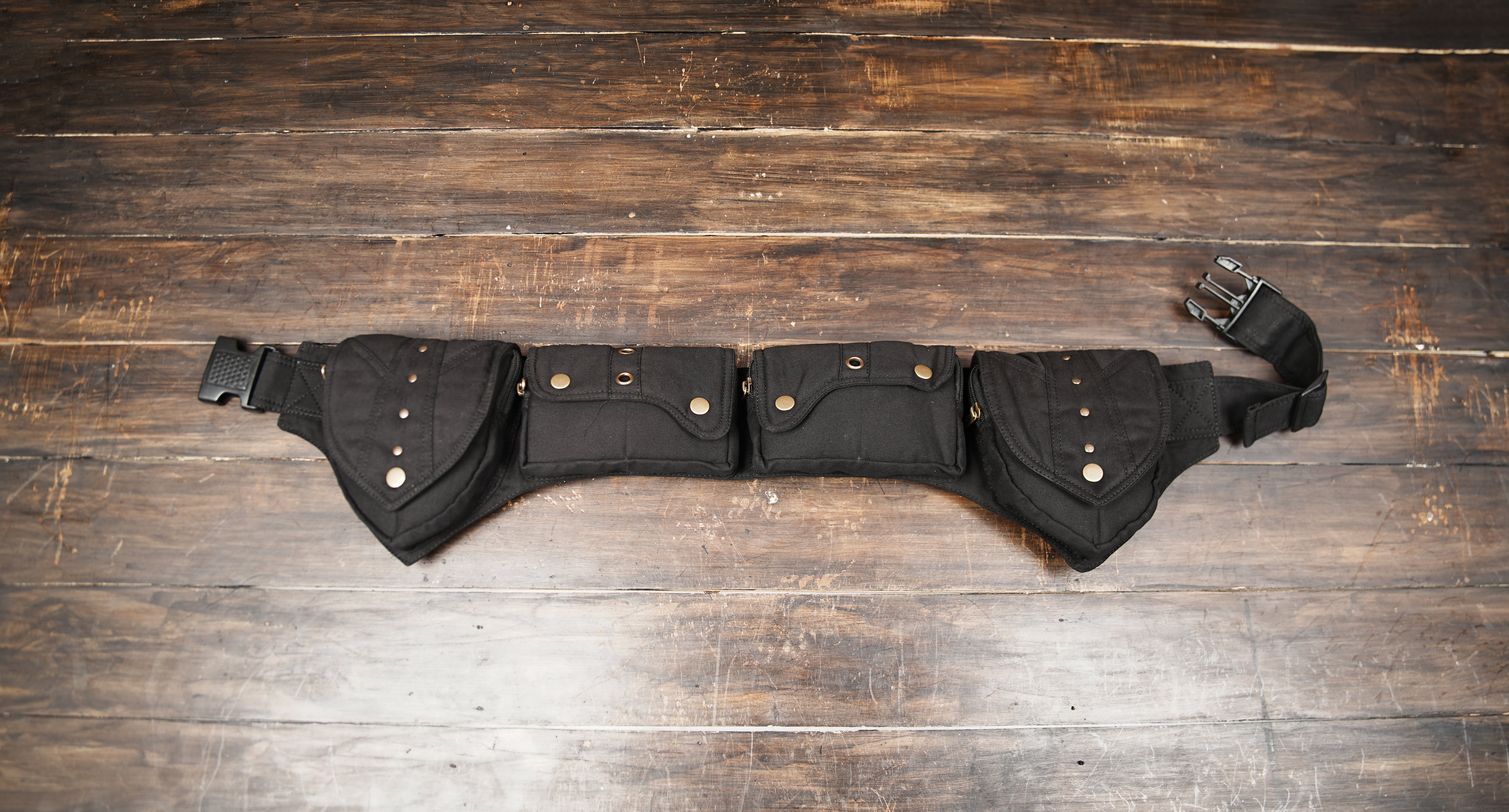 Black cotton utility belt with multiple storage pockets and adjustable strap