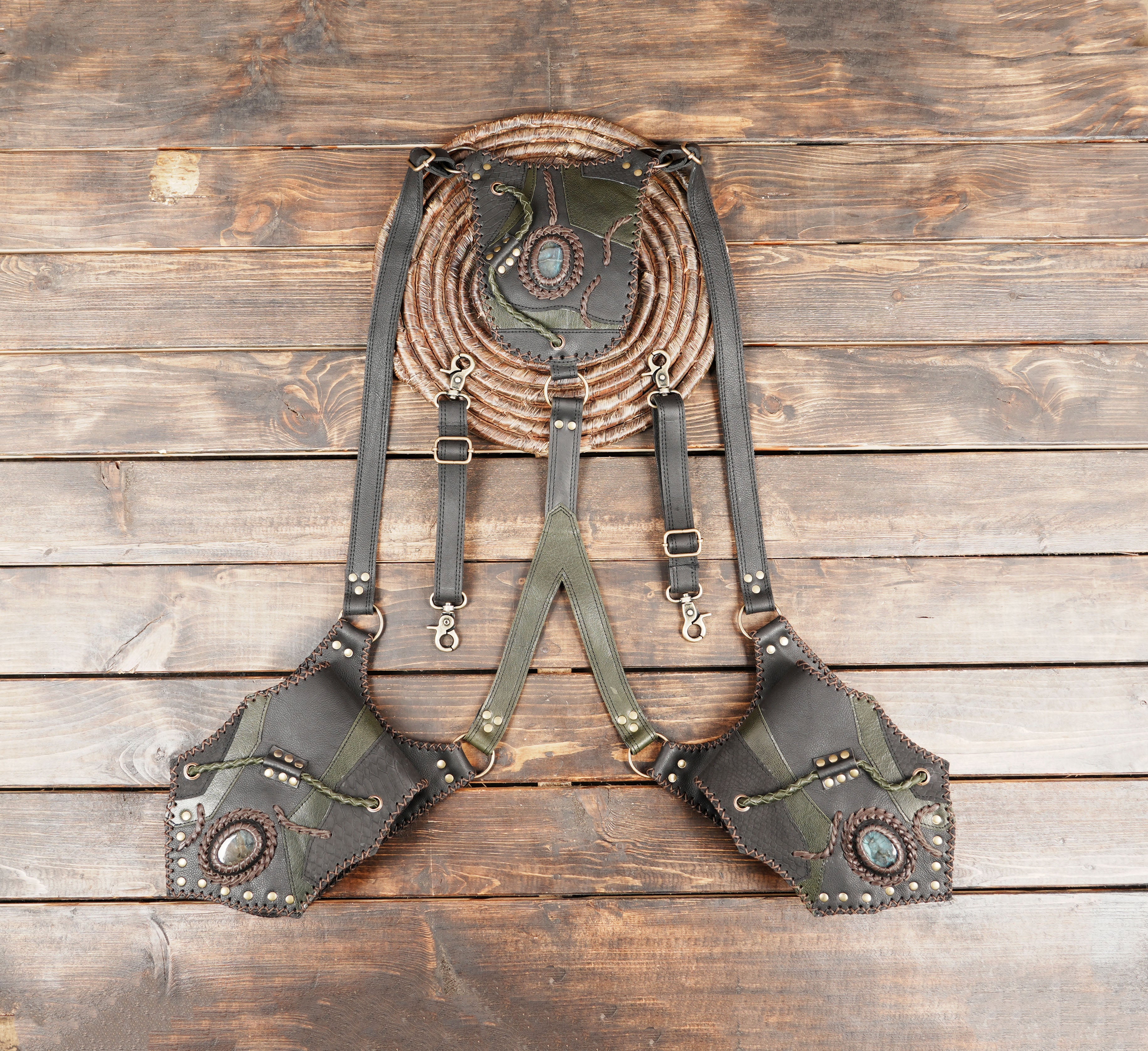 Handmade leather holster harness with gemstone accents and steampunk stitching design.