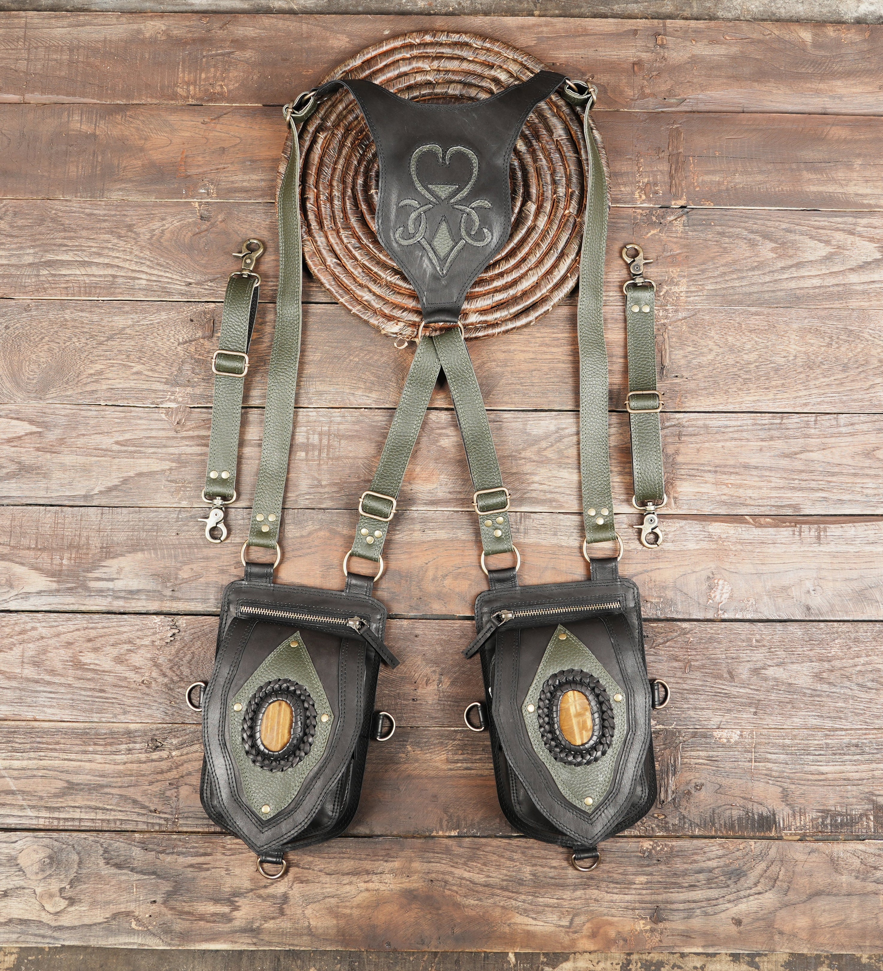 Black and green leather dual shoulder holster with gemstone centerpiece