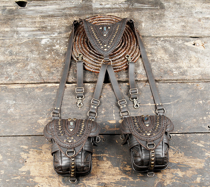 “Dark brown leather double holster with tribal patterns and gemstone accents”