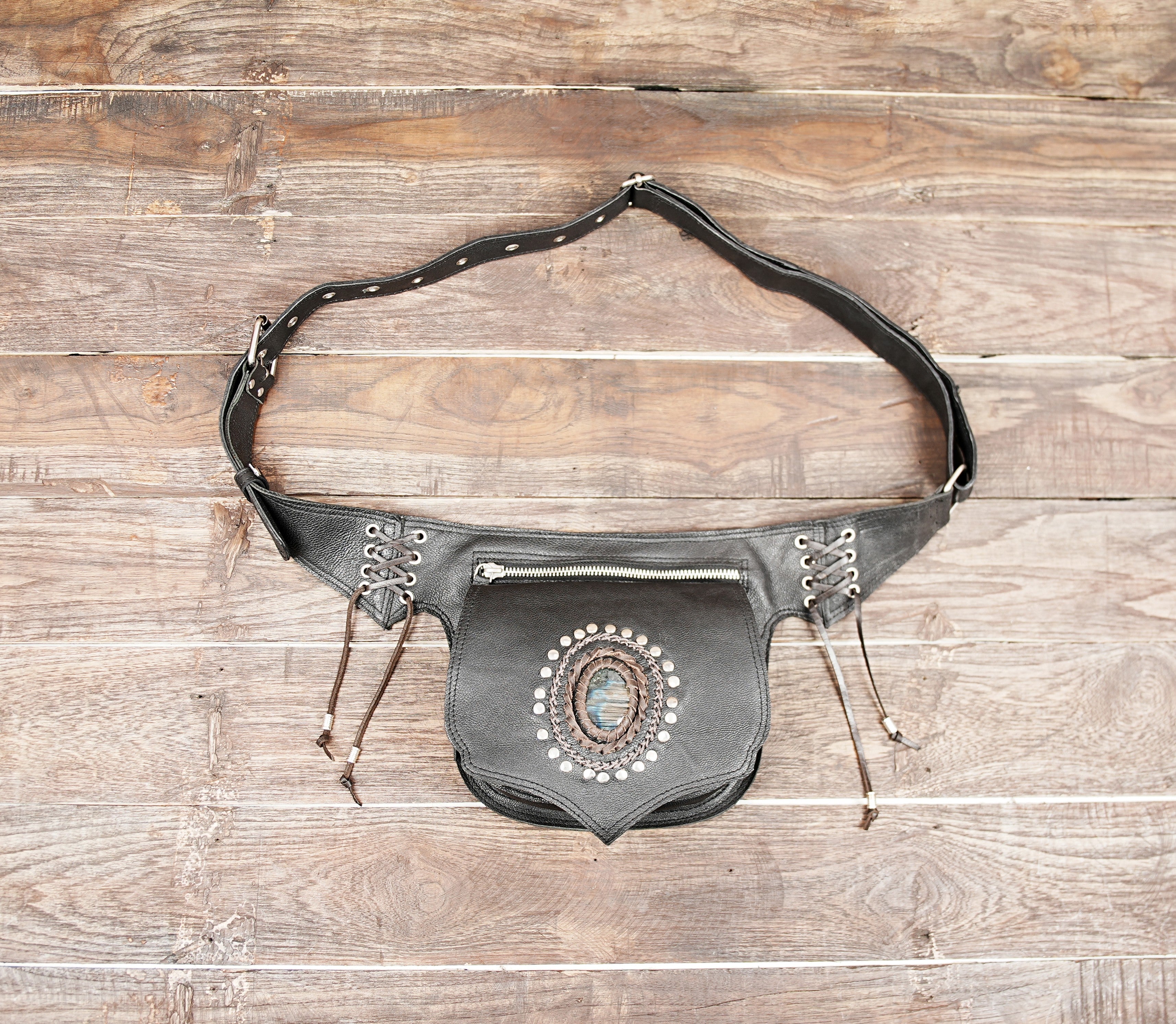 Handmade black leather waist belt bag with oval gemstone centerpiece and lace-up sides