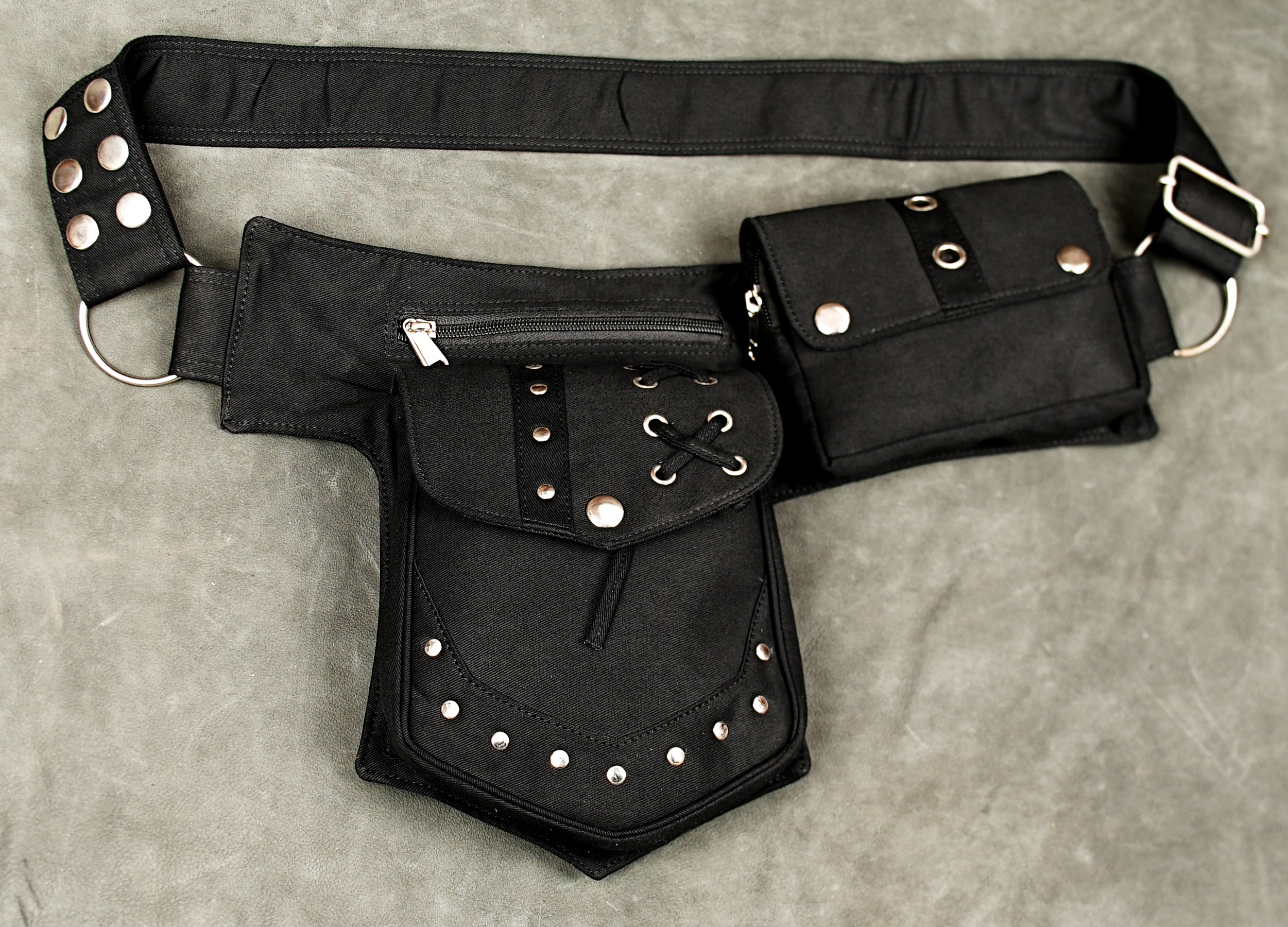 Black cotton utility waist belt with multiple pockets silver-tone studs and adjustable strap for festivals.