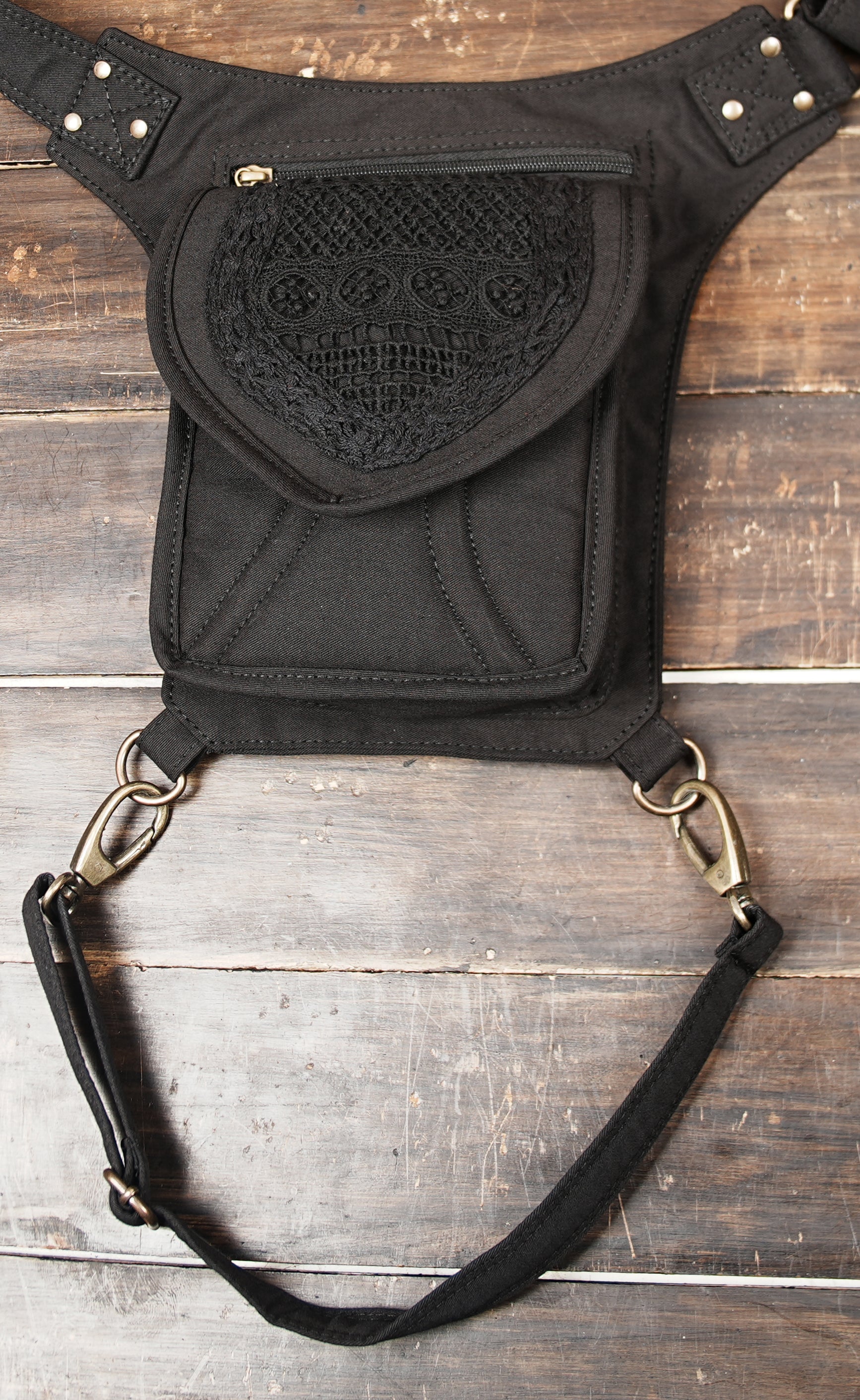 Unisex cotton canvas hip and thigh bag with multi-pocket zippered storage for concerts and travel.