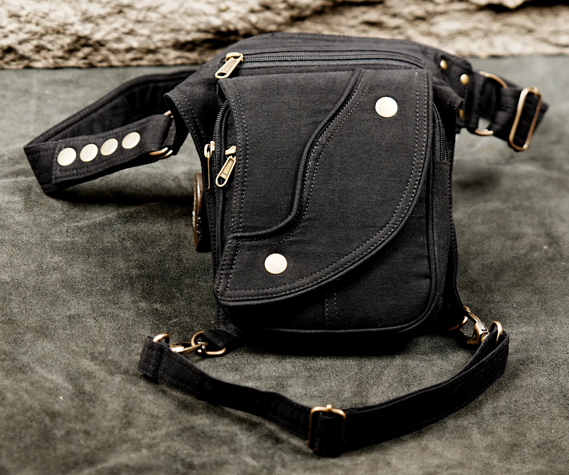 Black canvas thigh holster bag with adjustable leg strap and snap button pocket