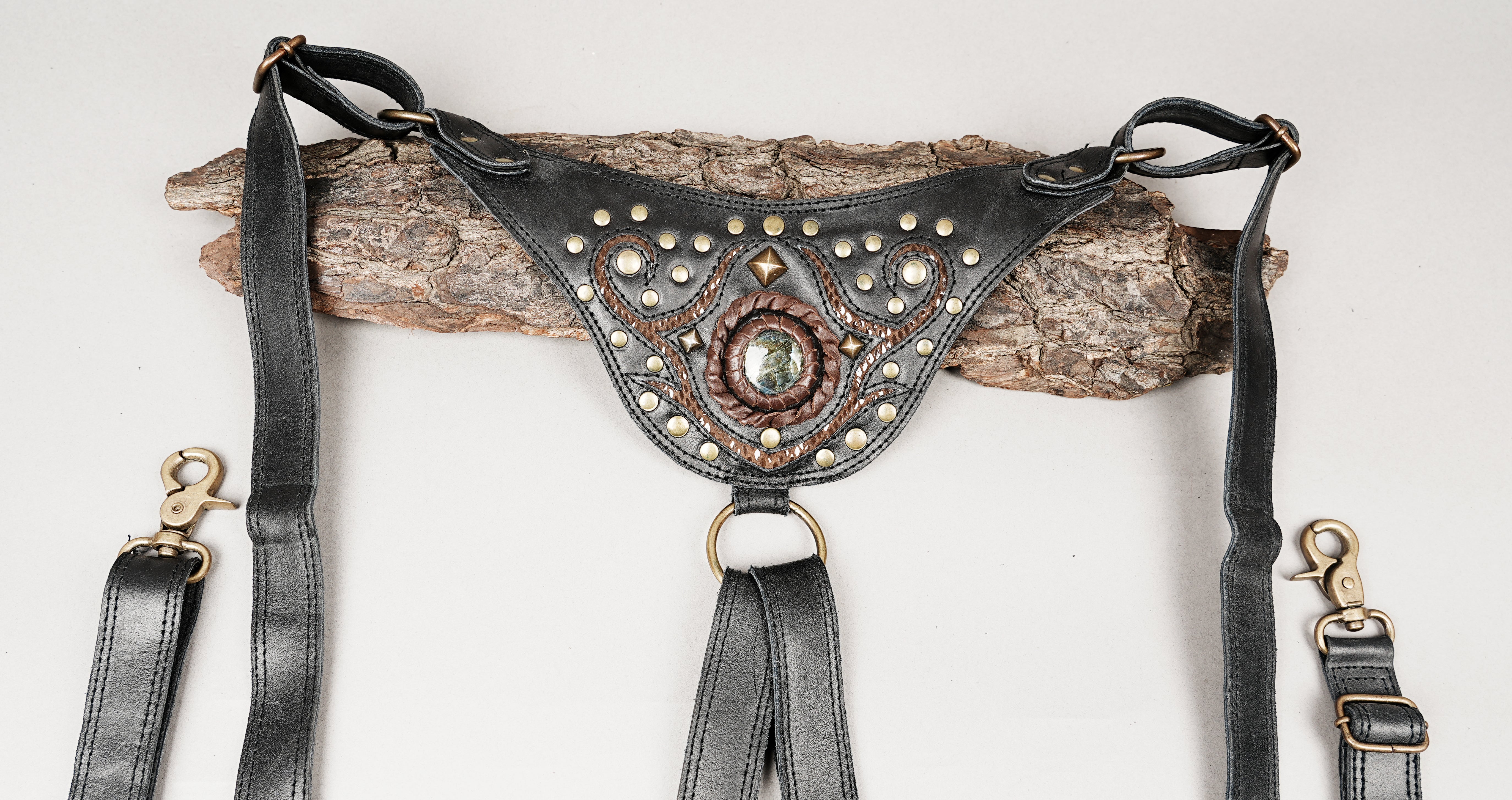 Artisan leather harness bag with vintage metal hardware and embossed design