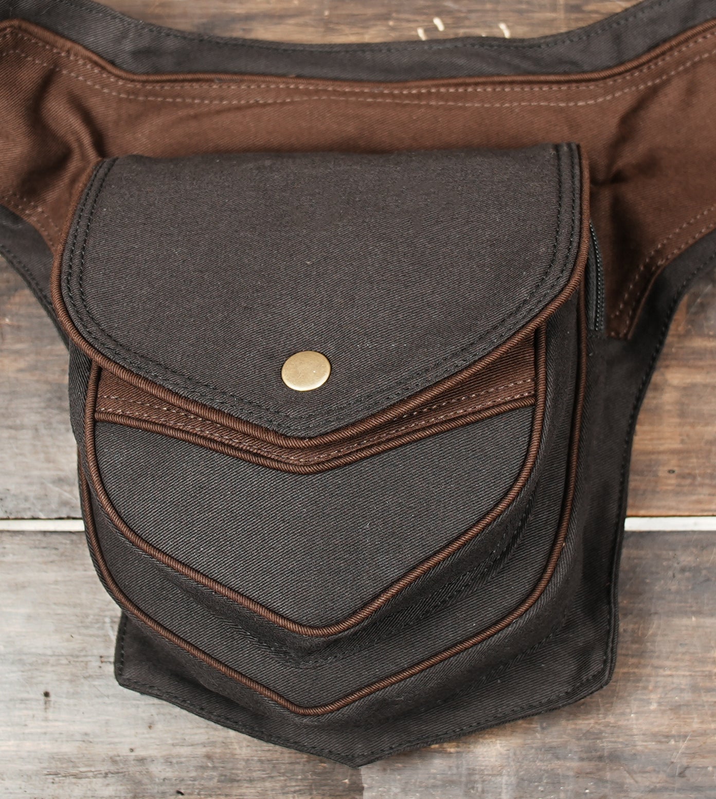 Black cotton waist belt bag with front flap pocket and adjustable buckle strap