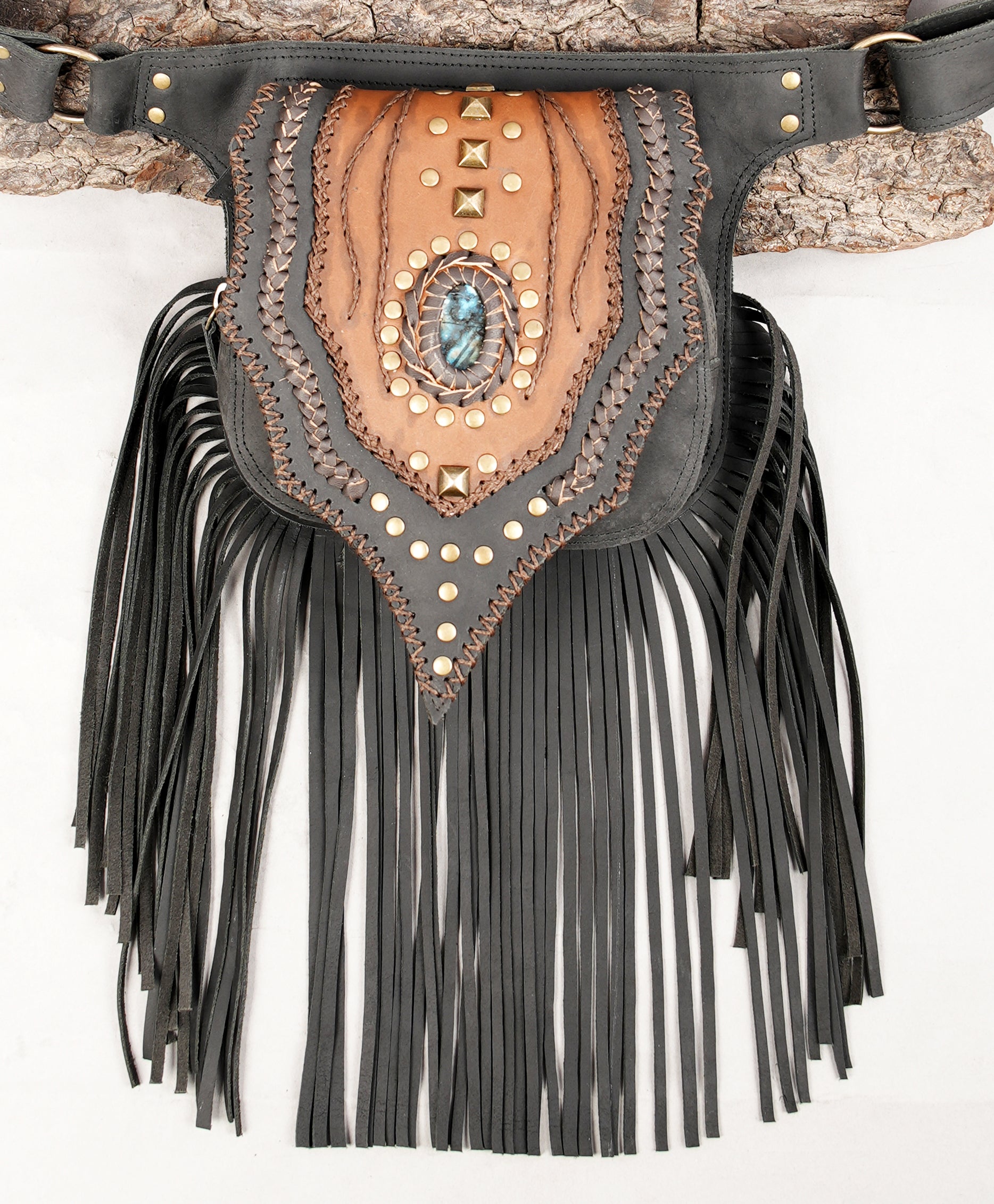 Artisan leather hip pouch with long fringe and centerpiece stone.
