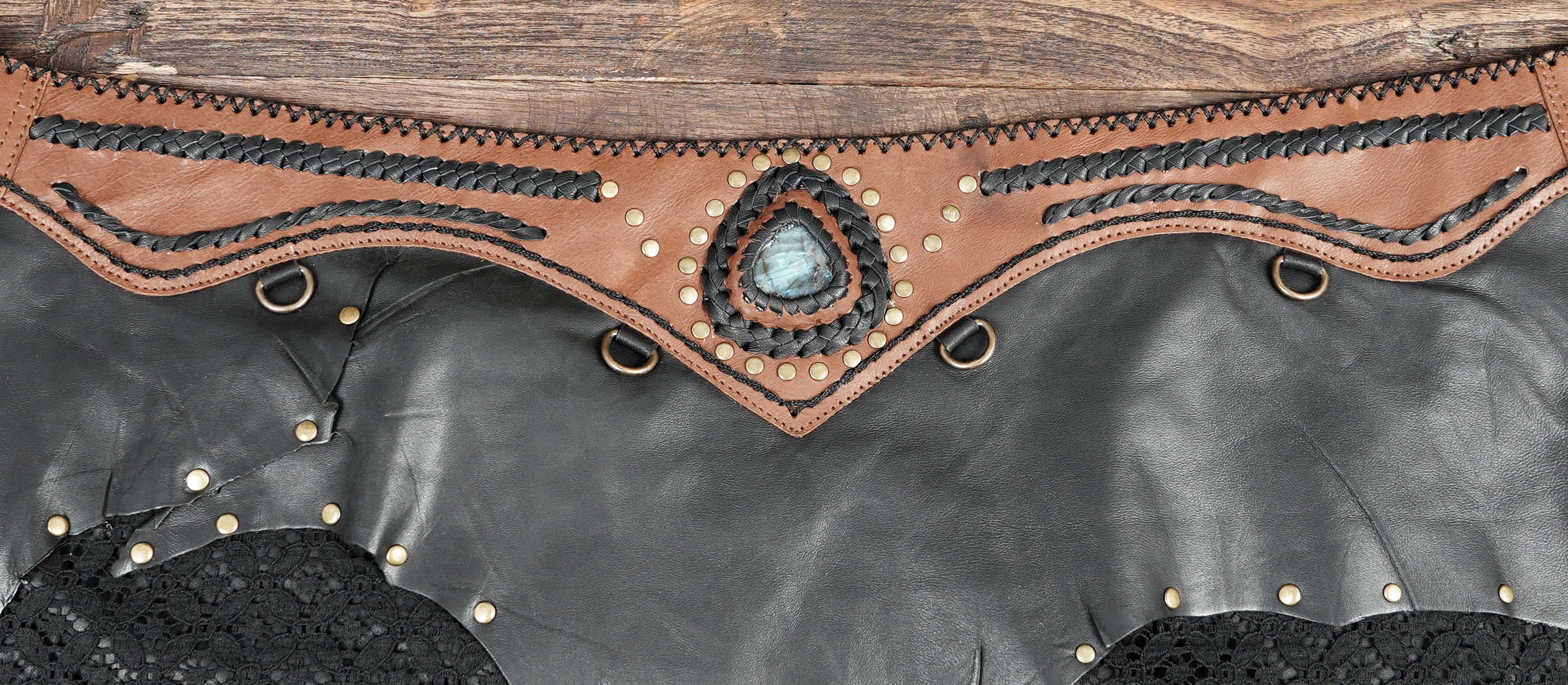 Handcrafted leather skirt with natural stone detail.