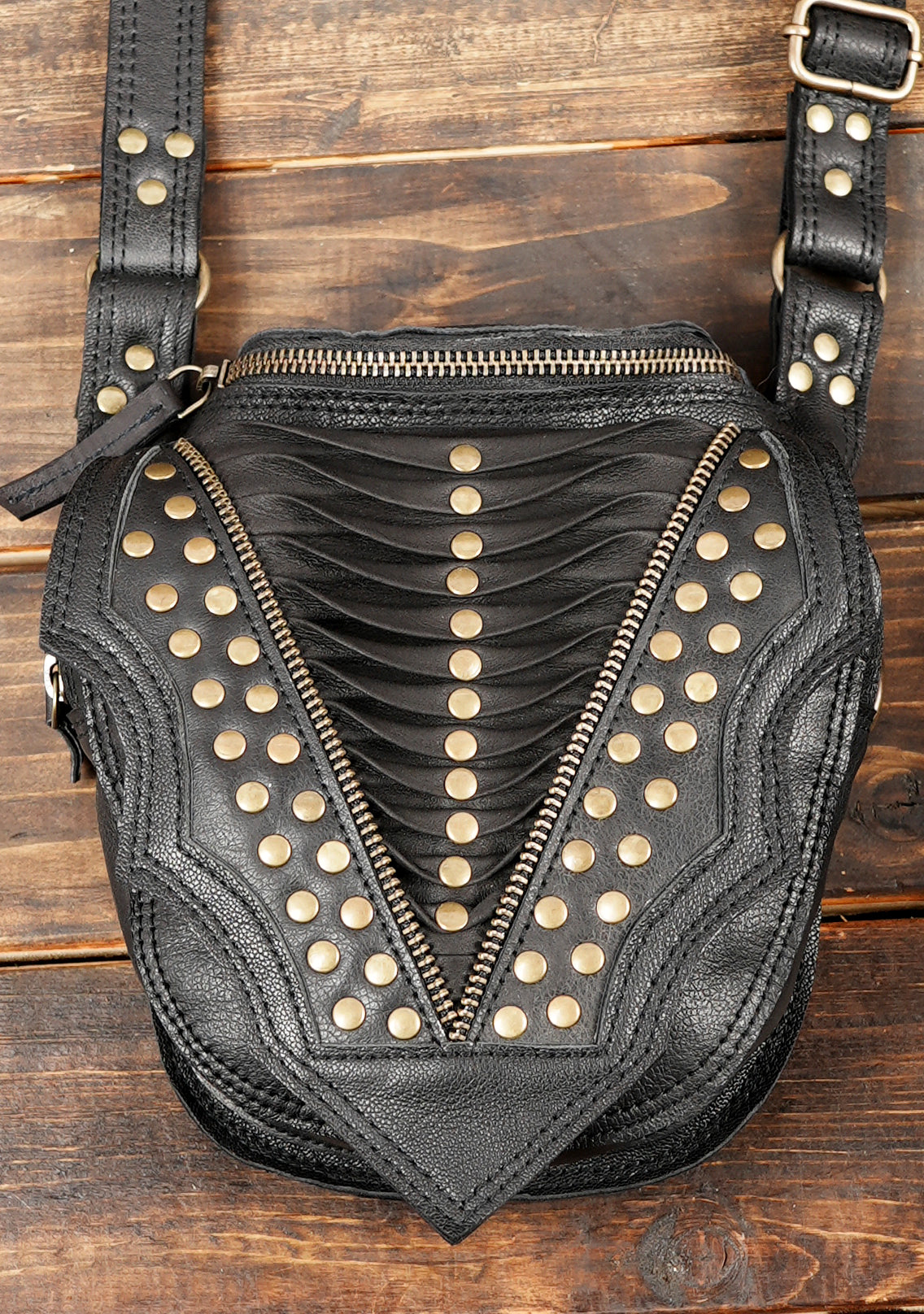 “Black leather chest holster with double bags and decorative stud pattern”