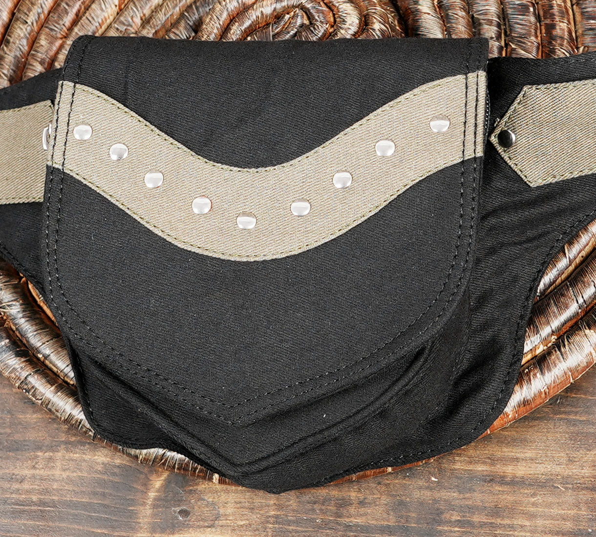 Handcrafted canvas fanny pack from the USA, showcasing its unique two-tone design and metallic studs.