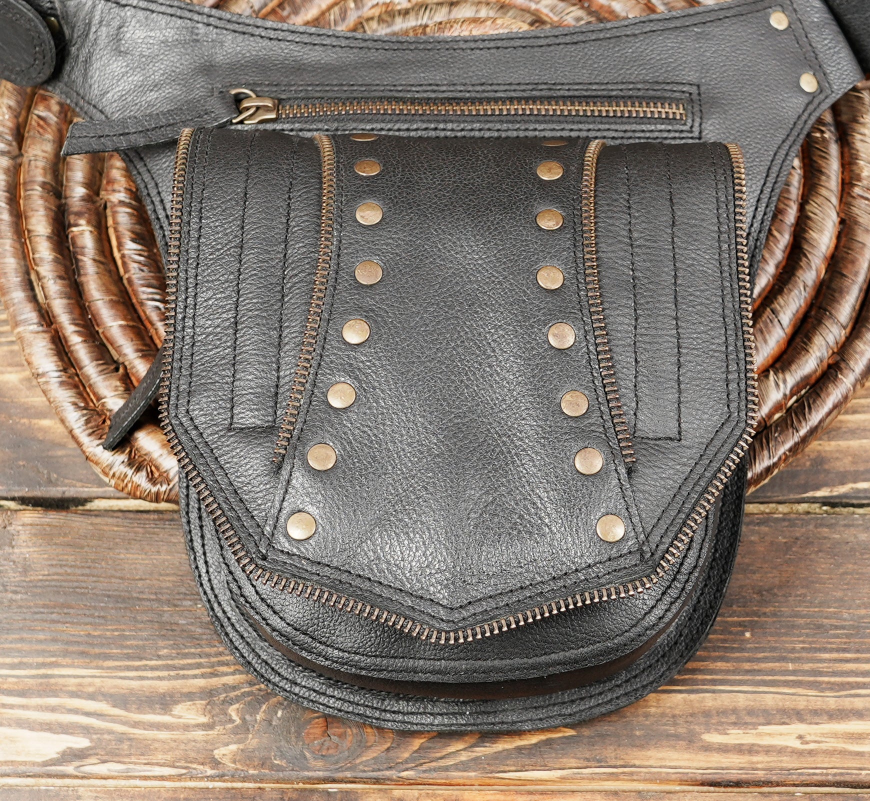 Close-up of belt buckle and adjustable strap on leather hip bag