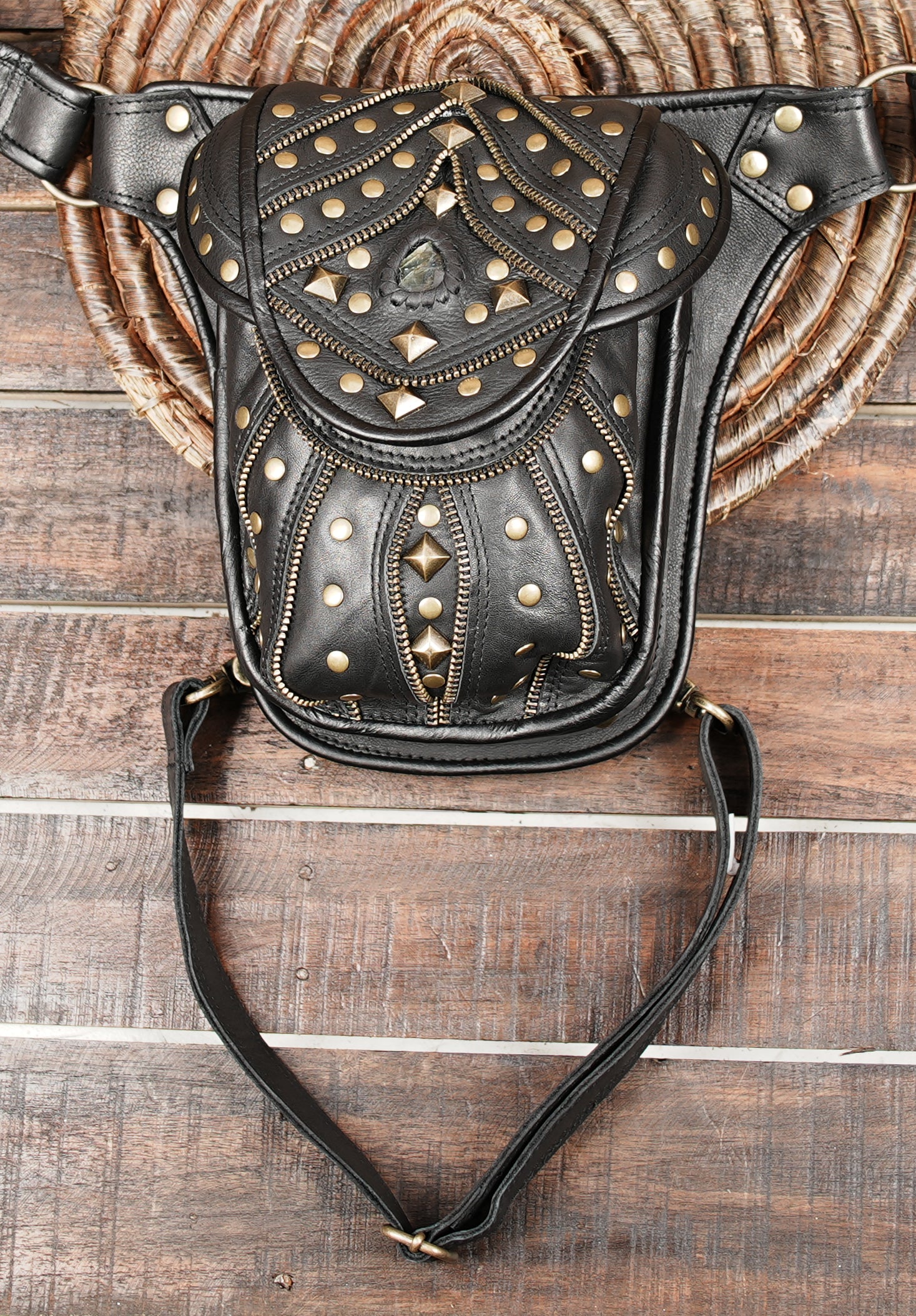 handcrafted studded leather waist bag with adjustable straps and brass accents
