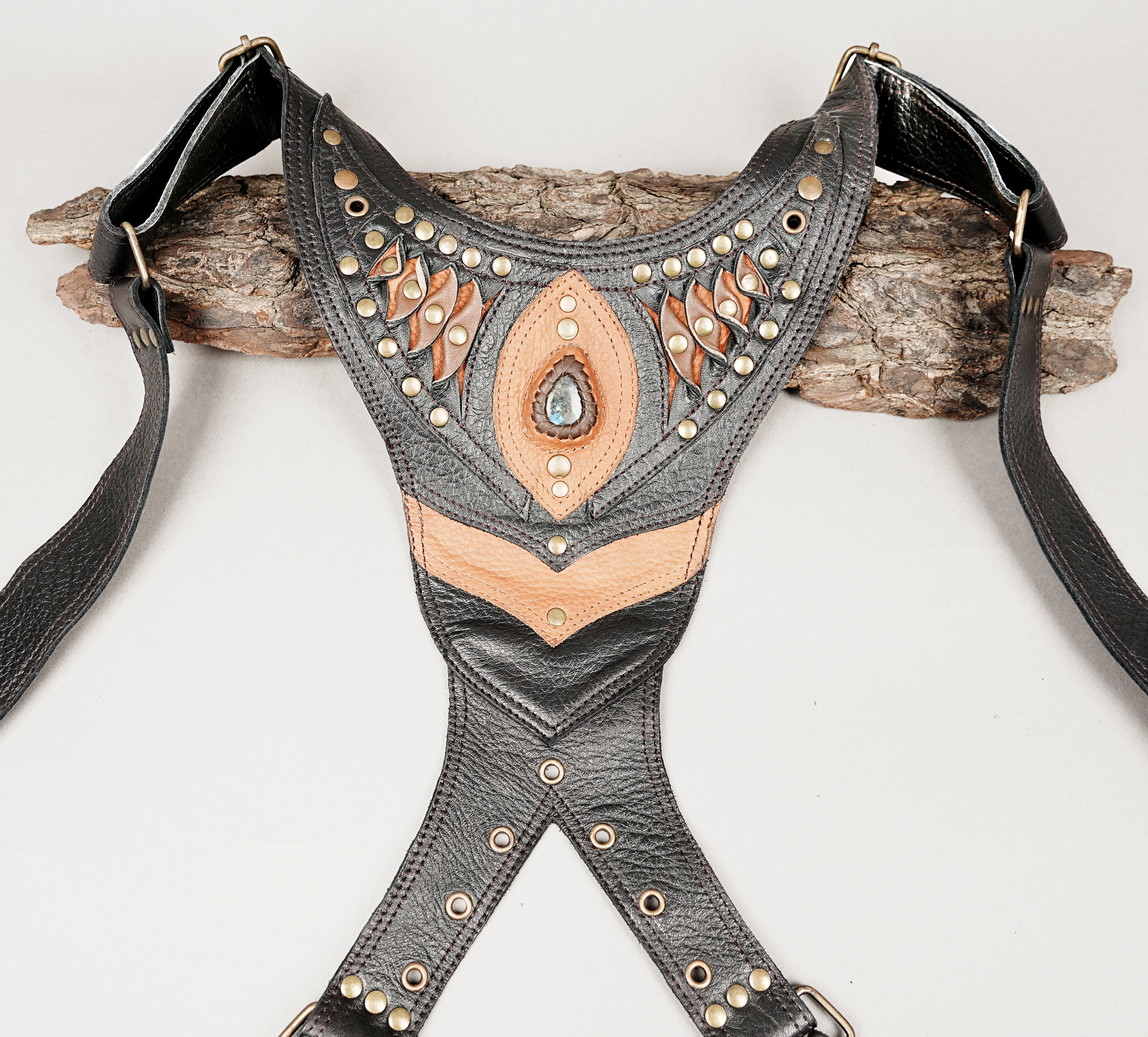 Gothic style leather shoulder rig with rivets and gemstone centerpiece